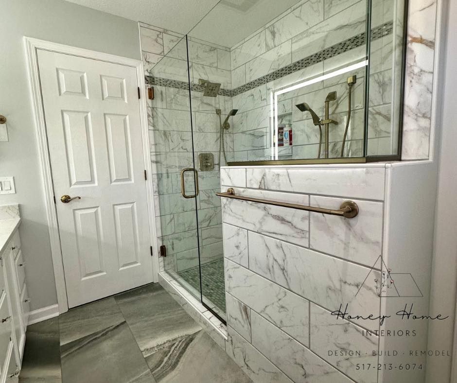 Woman with long blonde hair, smiling, standing in front of blue tile wall and white cabinets.