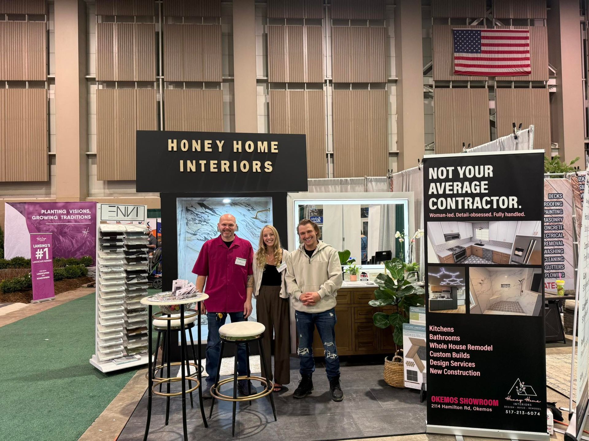Woman with long blonde hair, smiling, standing in front of blue tile wall and white cabinets.