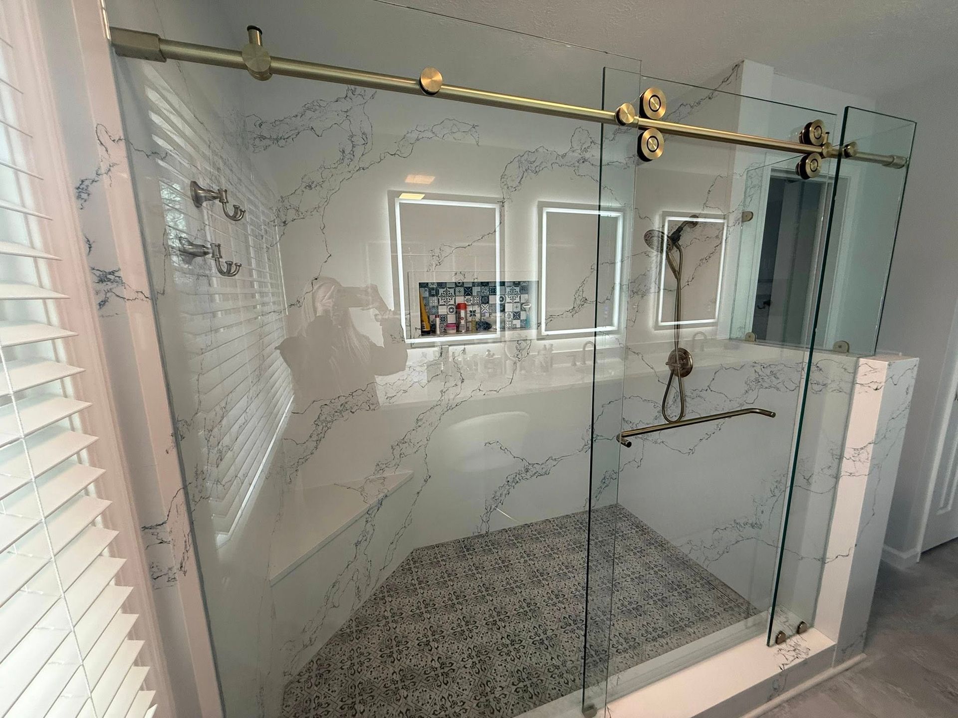 White fireplace with tile surround, artwork above, and dark gray hearth rug.