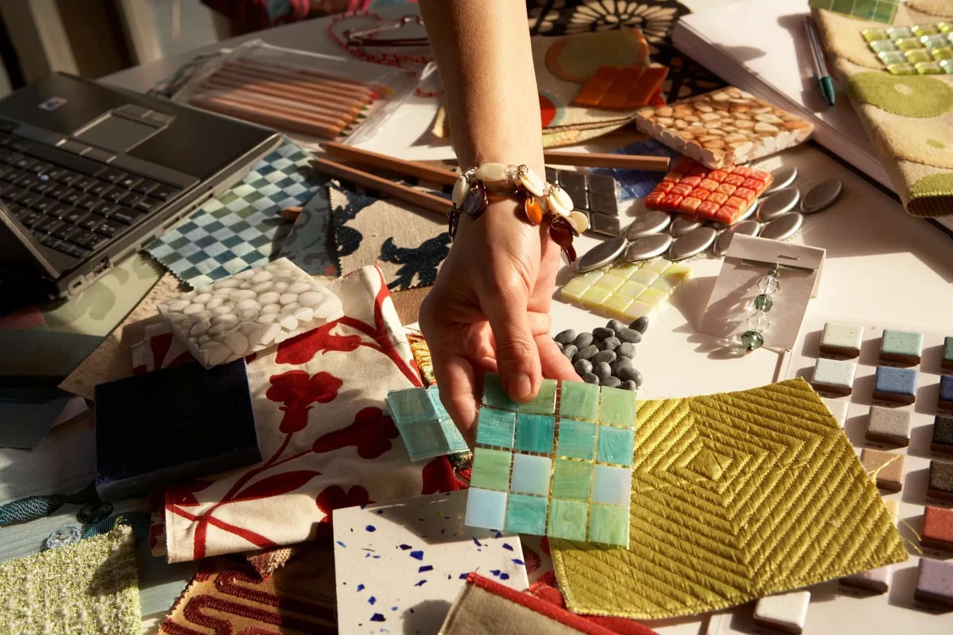 A person is picking up a piece of fabric on a table