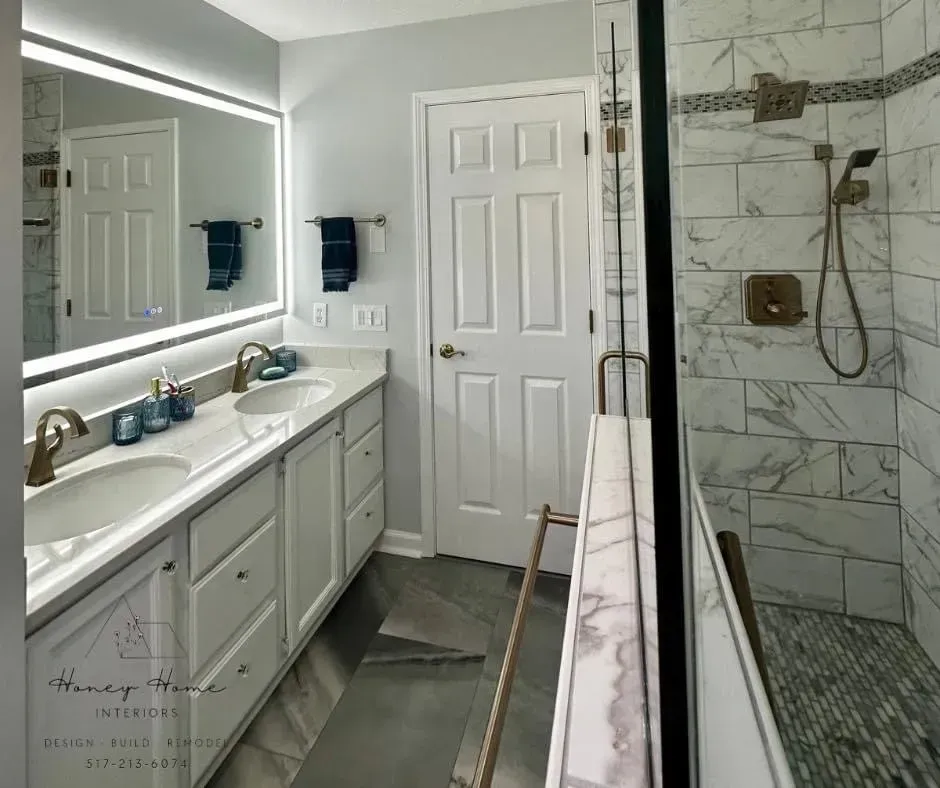 A bathroom with two sinks , a shower and a mirror.
