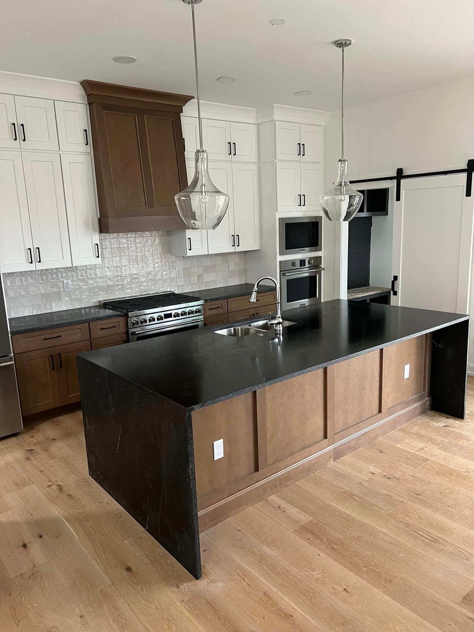 There is a large island in the middle of the kitchen.