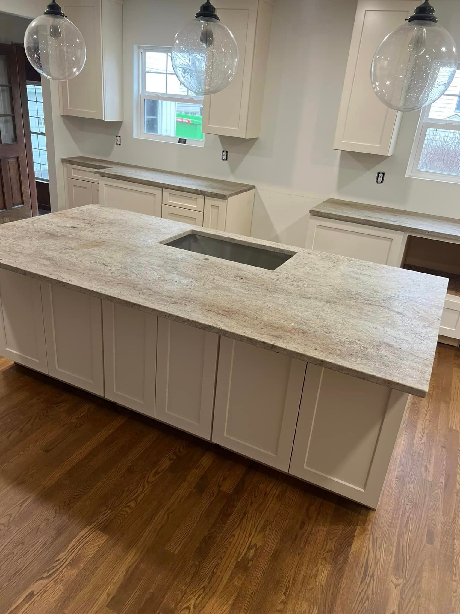 A kitchen with a large island and a sink.