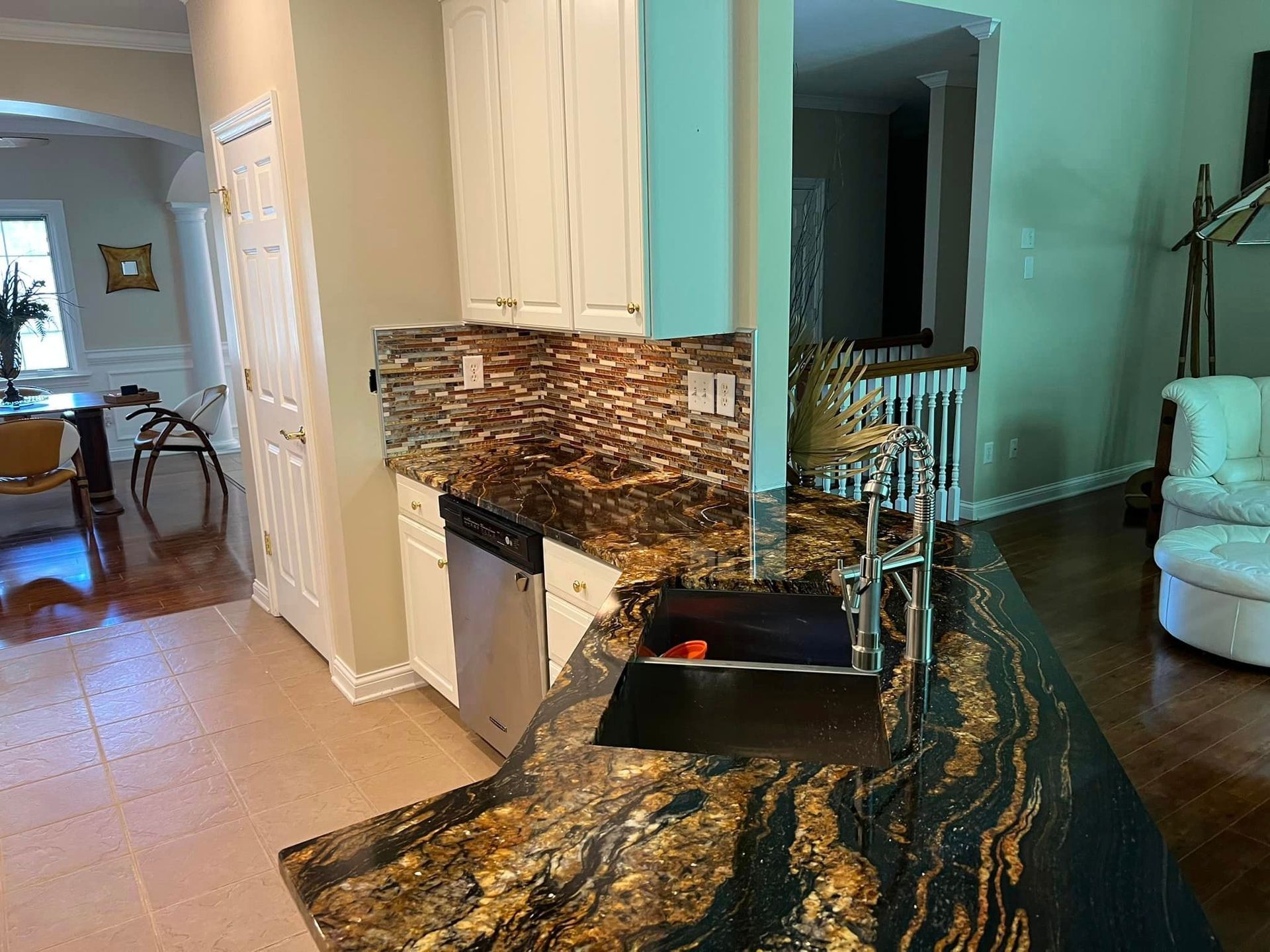 A kitchen with granite counter tops and a sink.