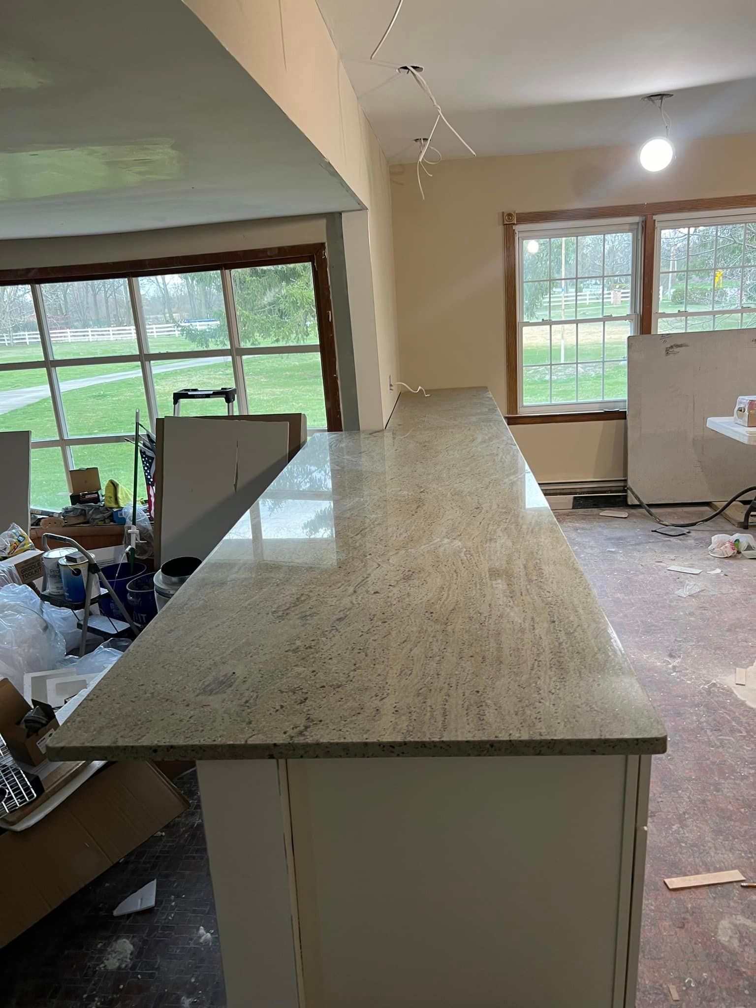 A long counter top in a room with a lot of windows.