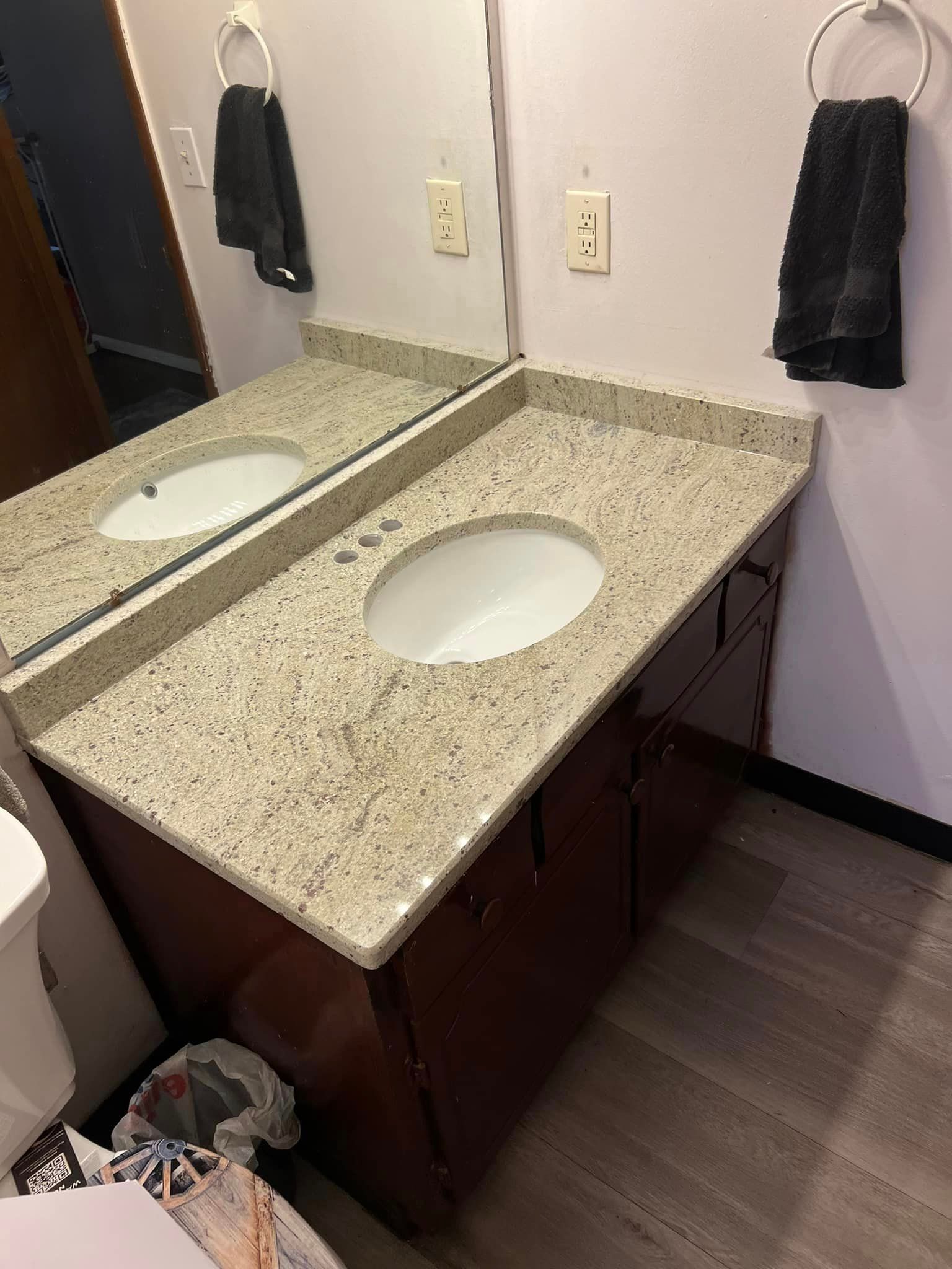 A bathroom with a sink , toilet and mirror.