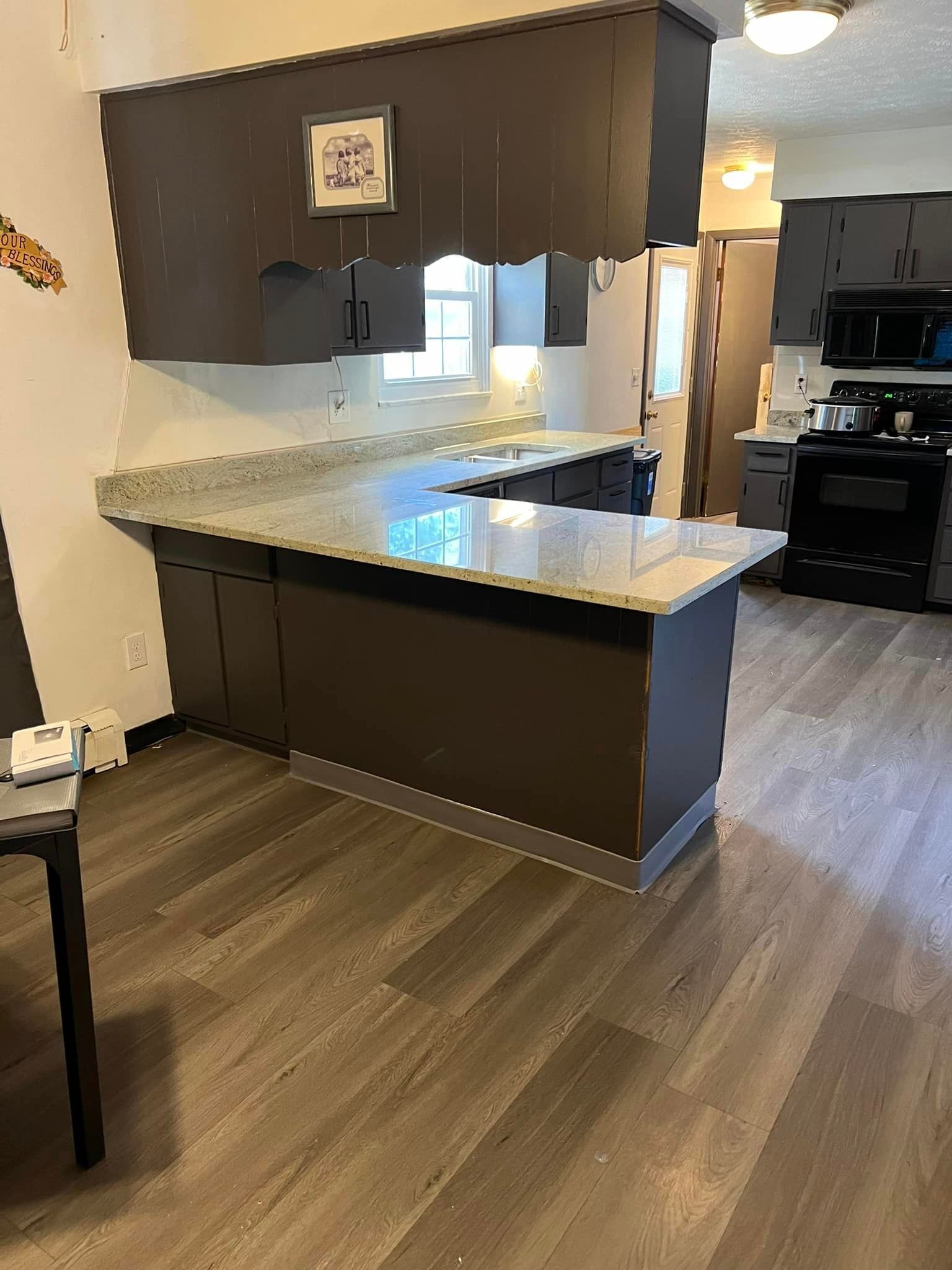 A kitchen with a large island in the middle of the room.