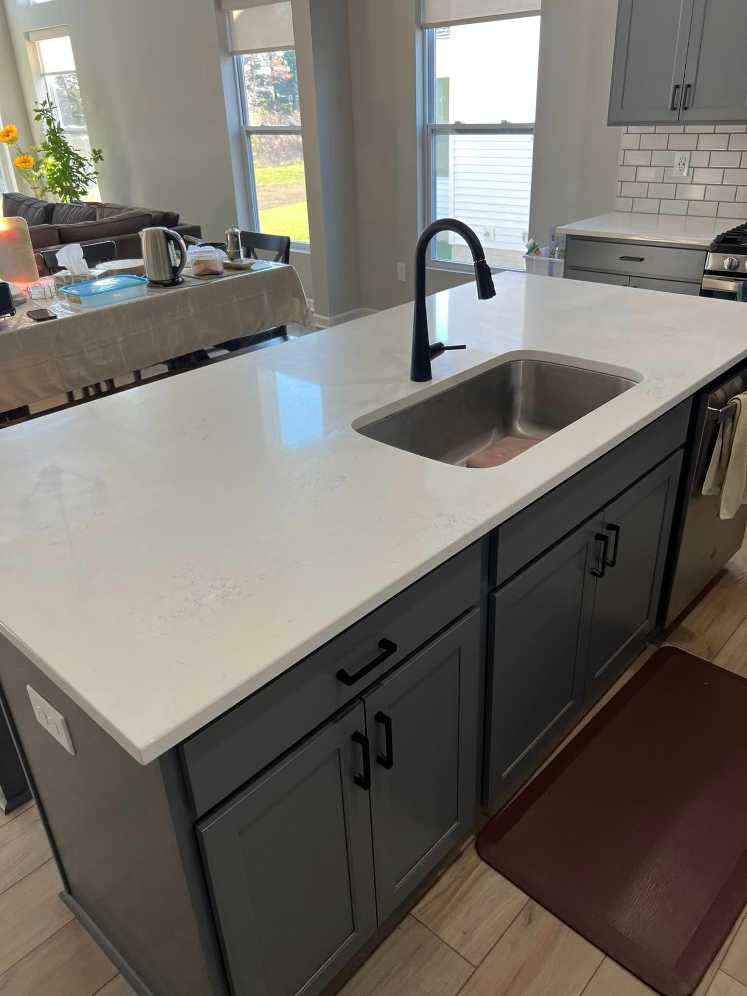 A kitchen with a large island and a sink.