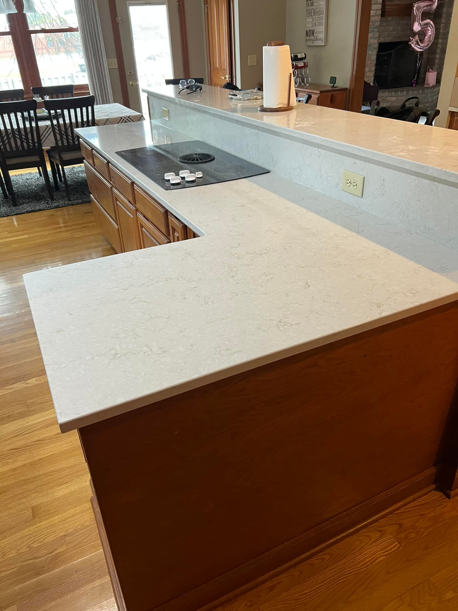 A kitchen with a large island and a stove top oven.
