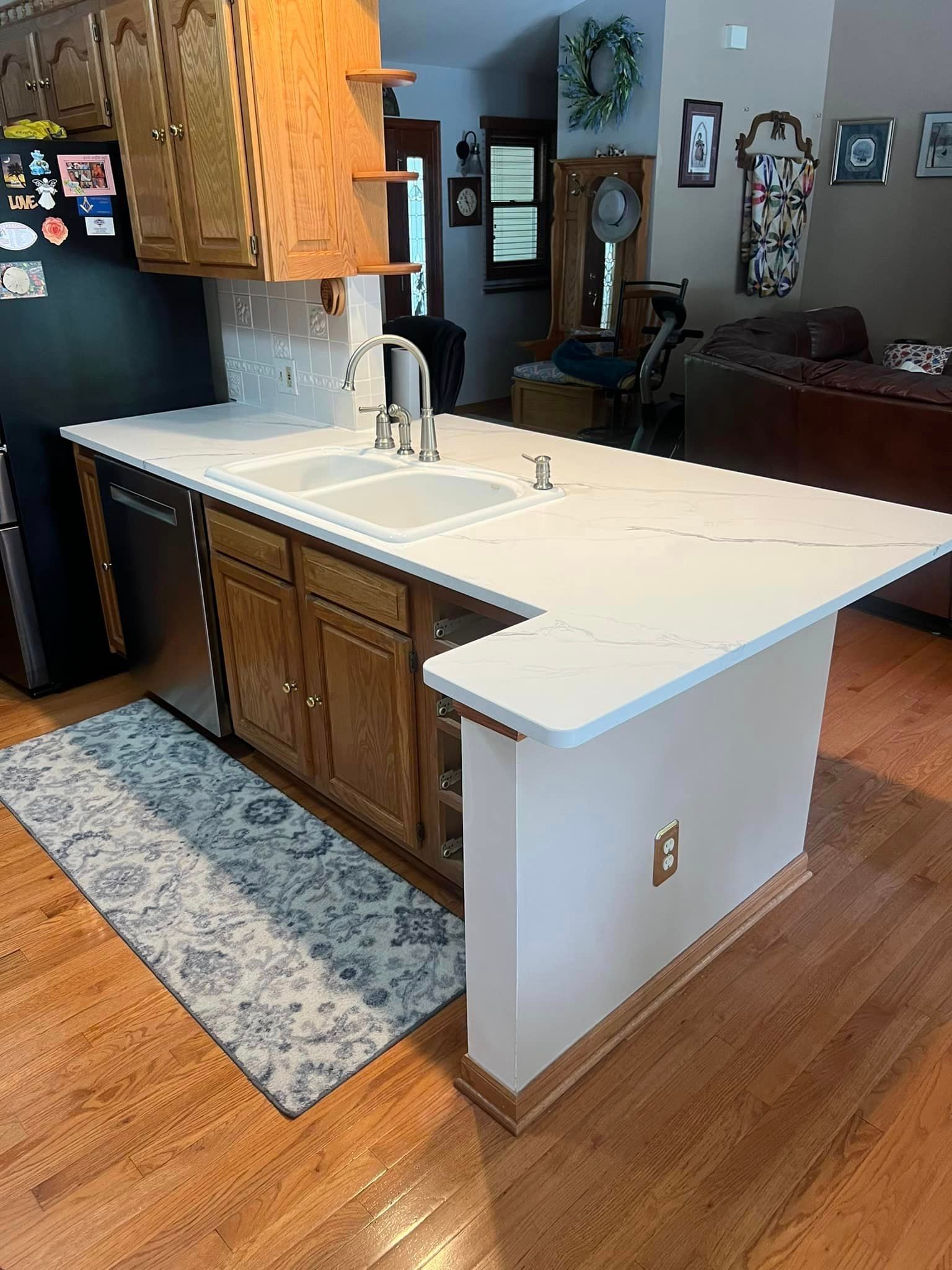 A kitchen with a large island and a sink.