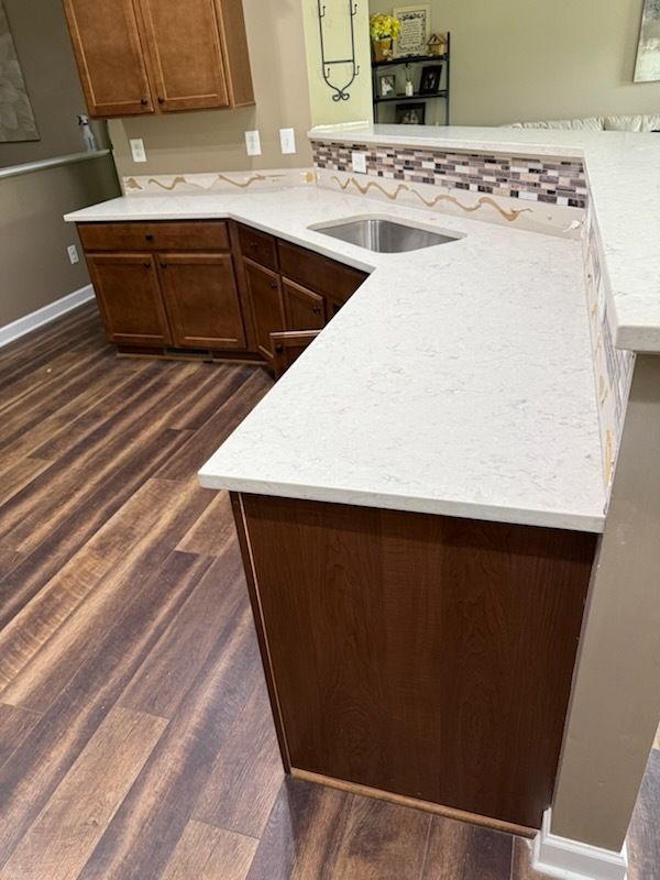 A kitchen with a stove top oven and a microwave