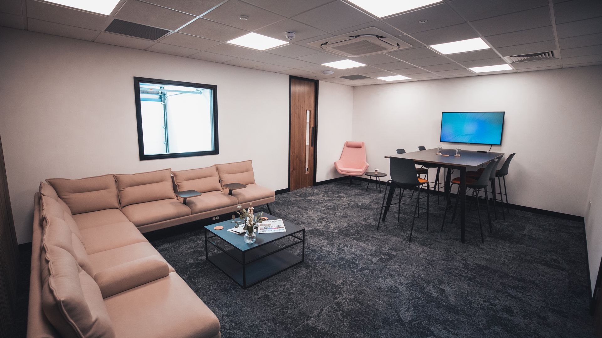 A living room with a couch , table and chairs.