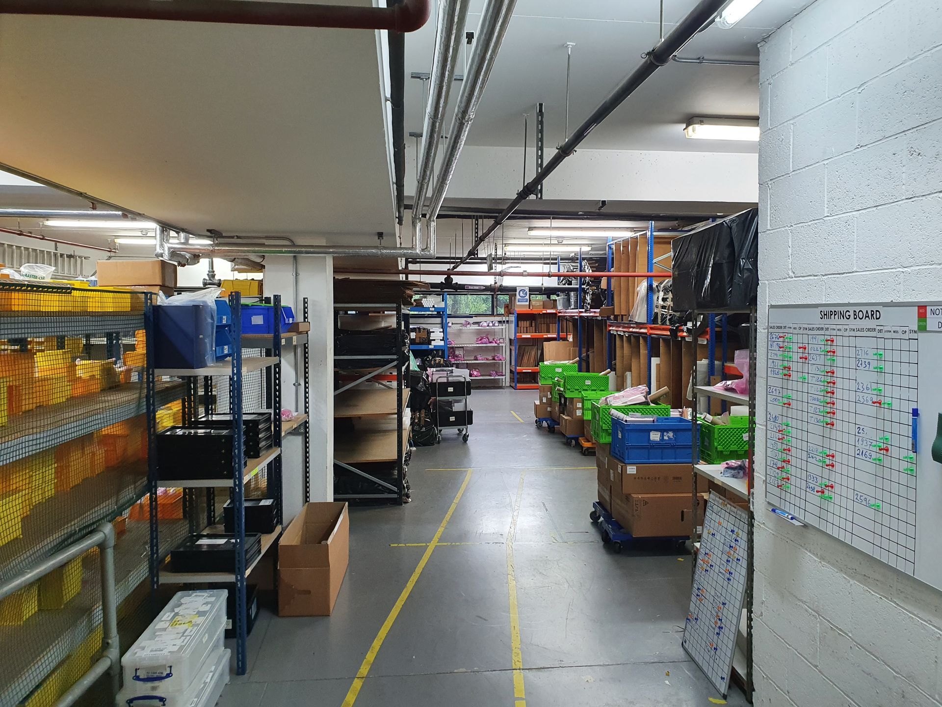 A large warehouse filled with lots of shelves and boxes.