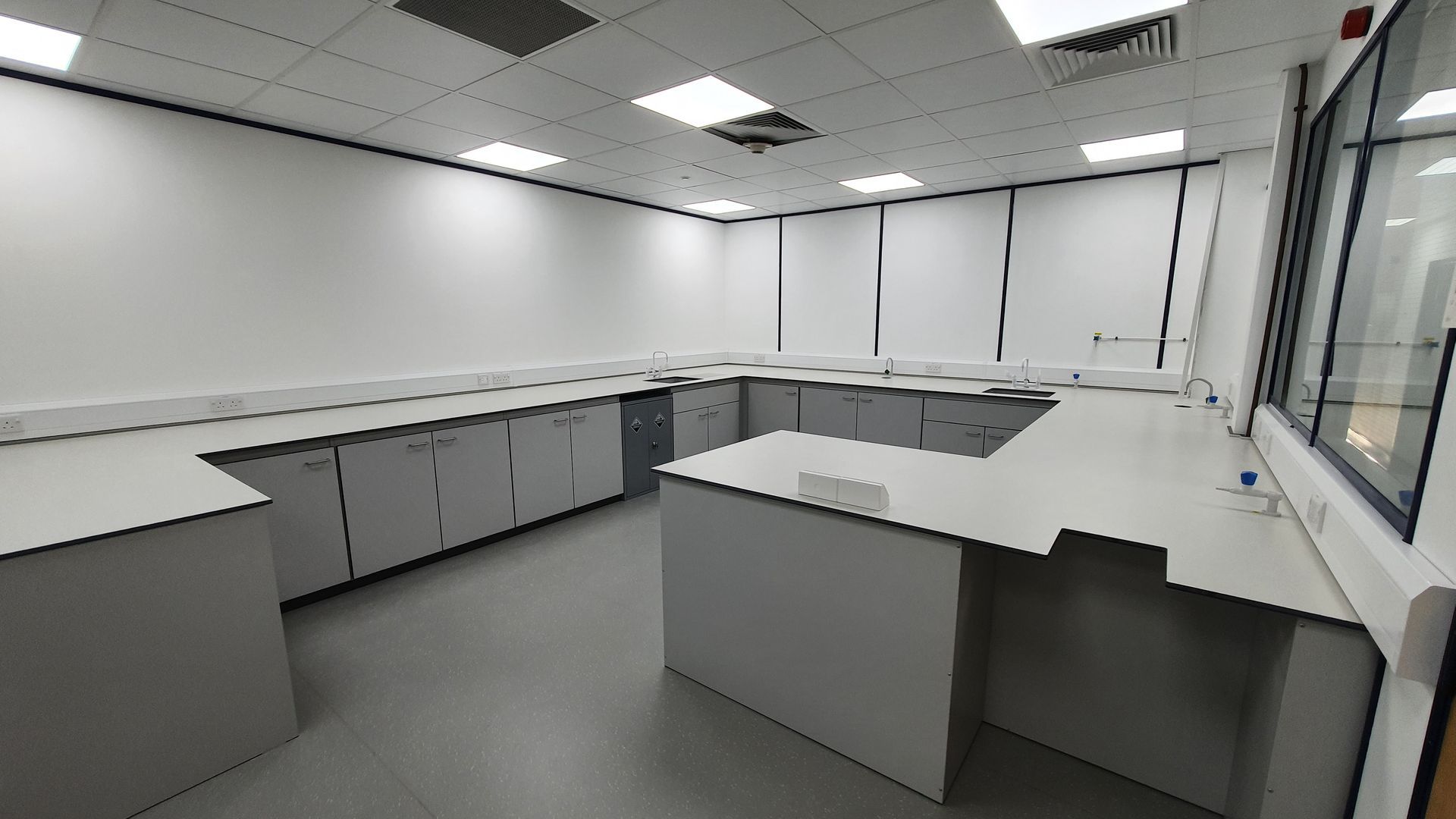 A large laboratory space with tables and cabinets