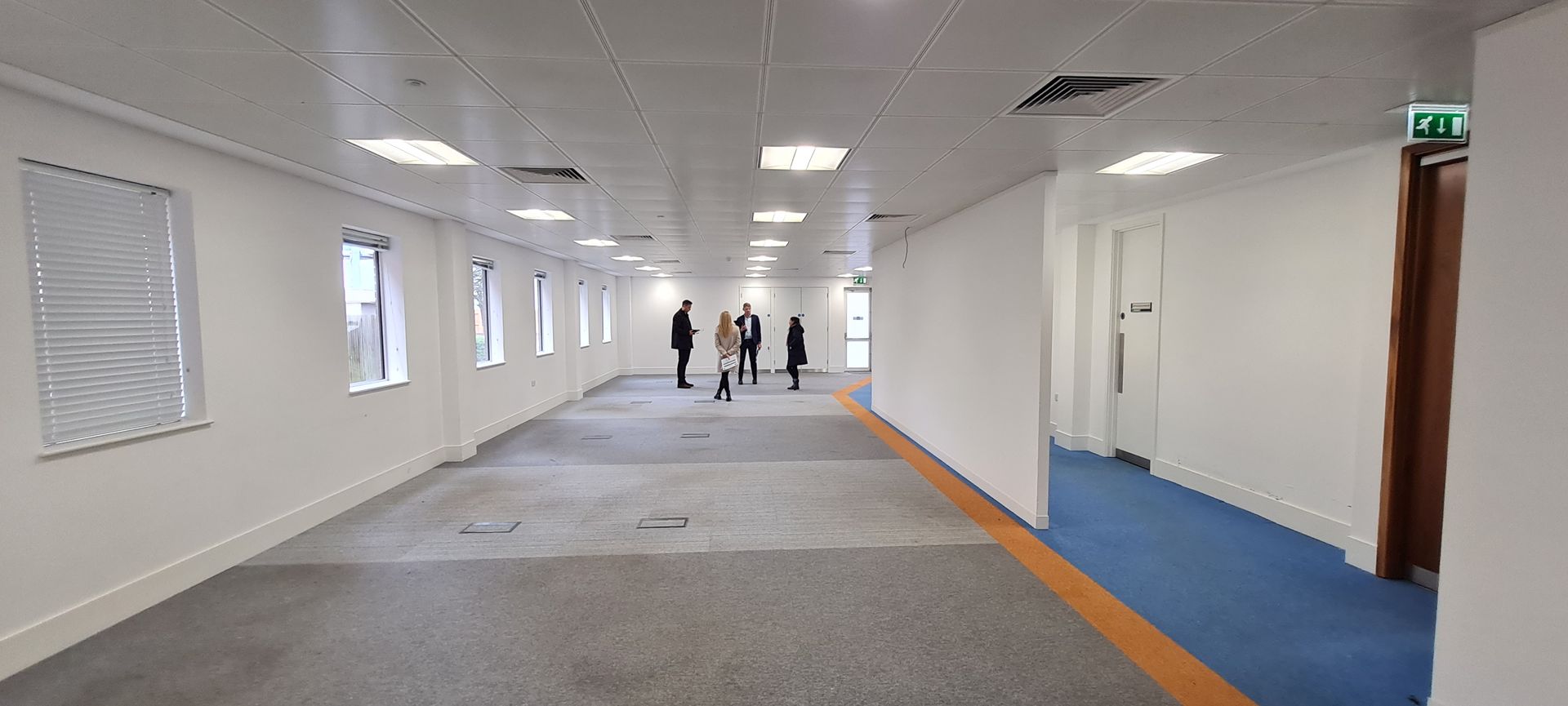 The office area of 6 Bell Street before renovation with grey, orange and blue carpets