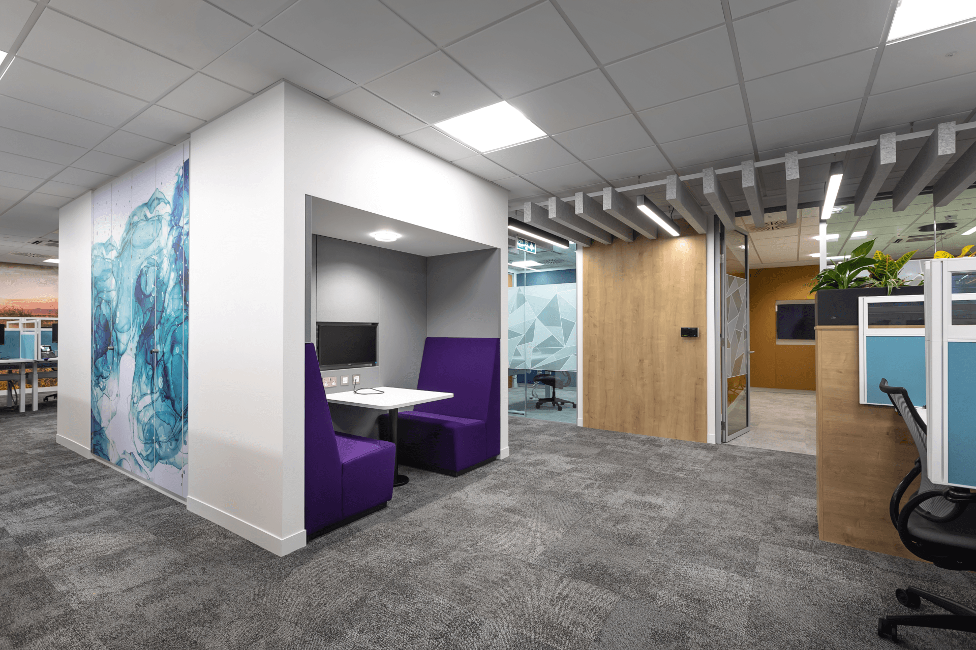 Hybrid working environment with a private meeting area with purple seats by Glenside