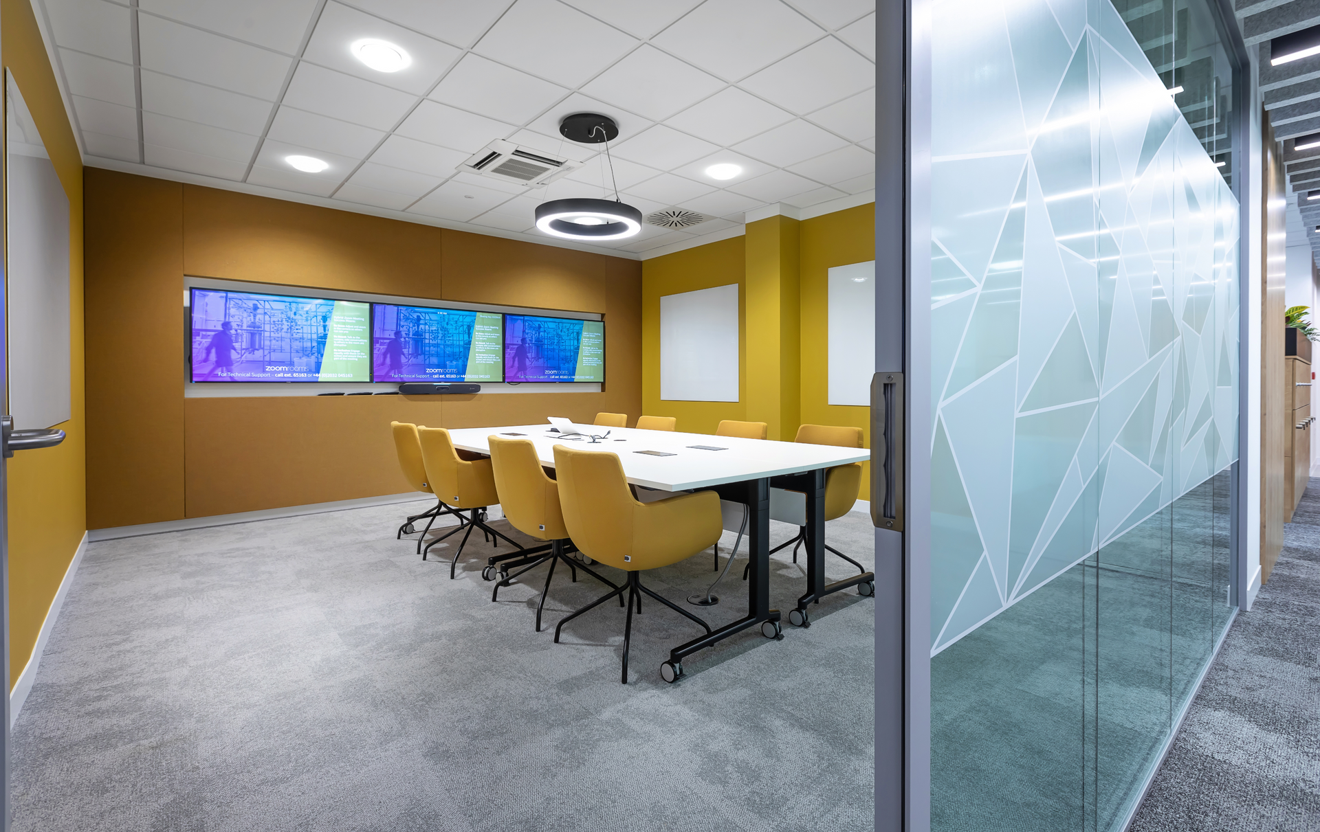 A conference room with a table and chairs in it.