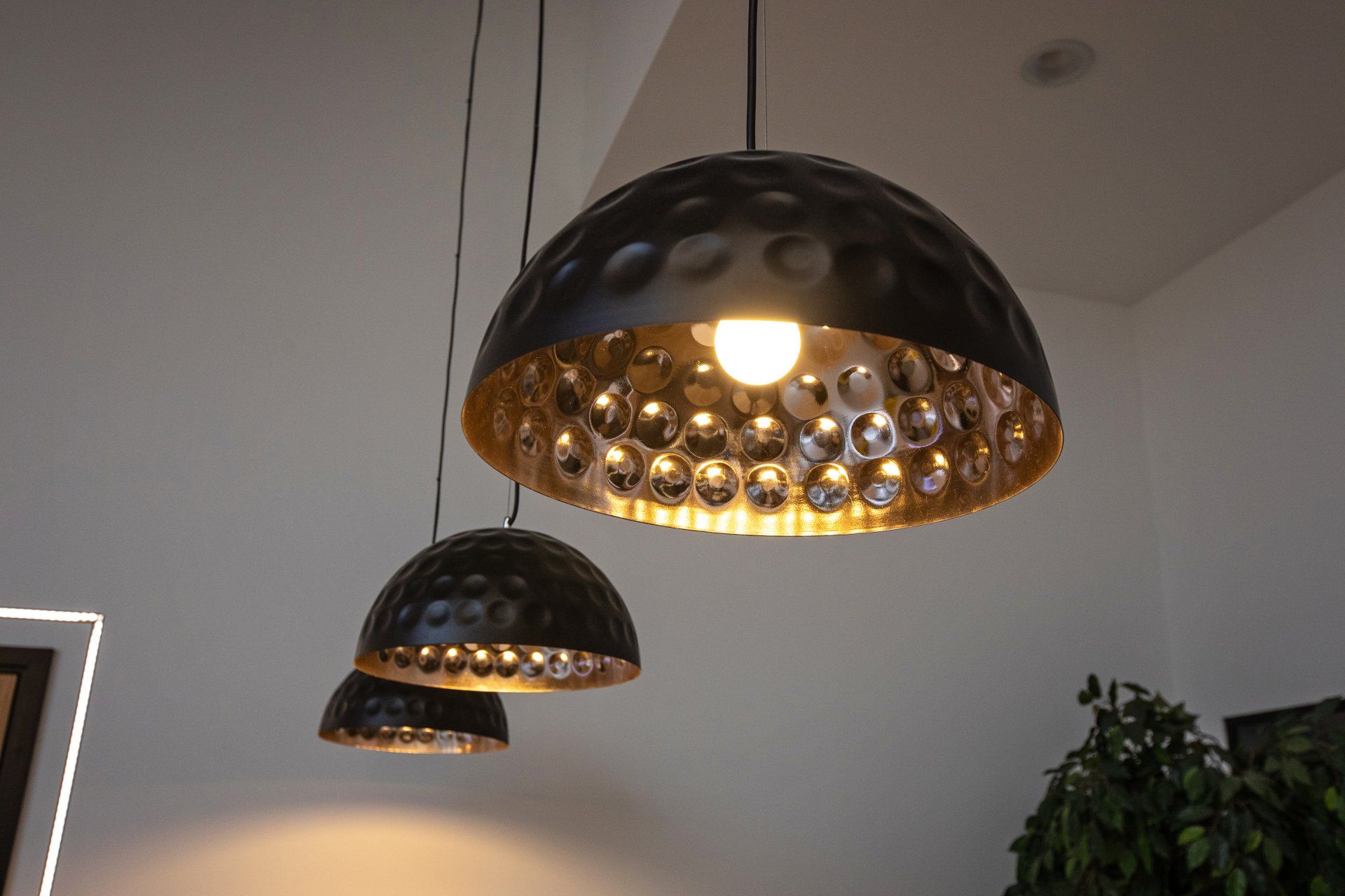 Two black and gold pendant lights are hanging from the ceiling