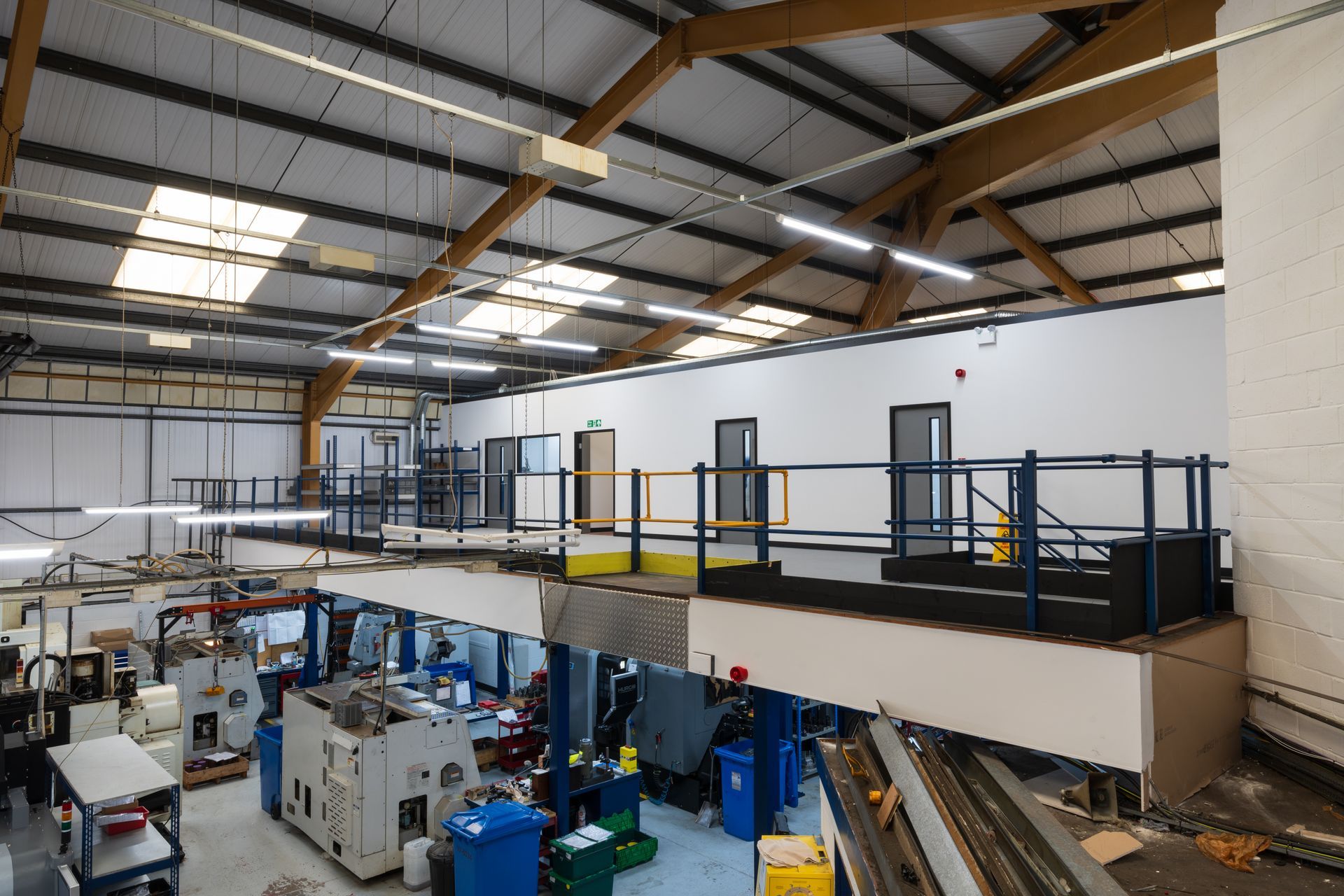 A large wooden building with a parking lot in front of it.