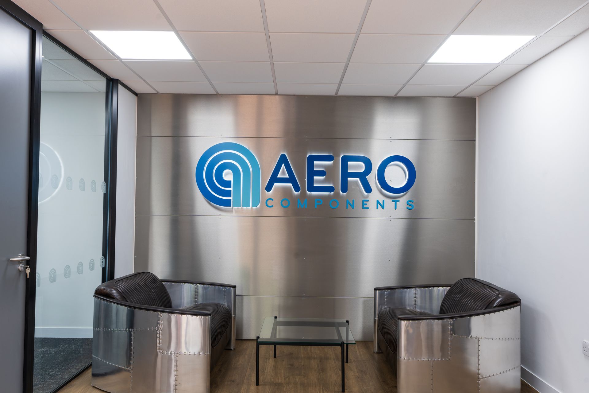 A large room with a lot of chairs and a television.