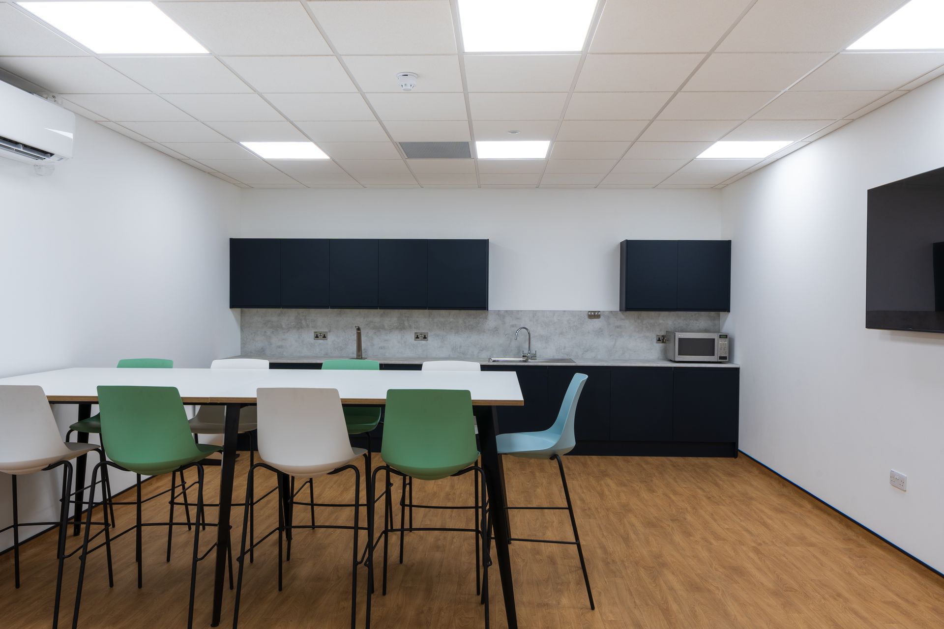 A bedroom with a bed , nightstand , and pictures on the wall.