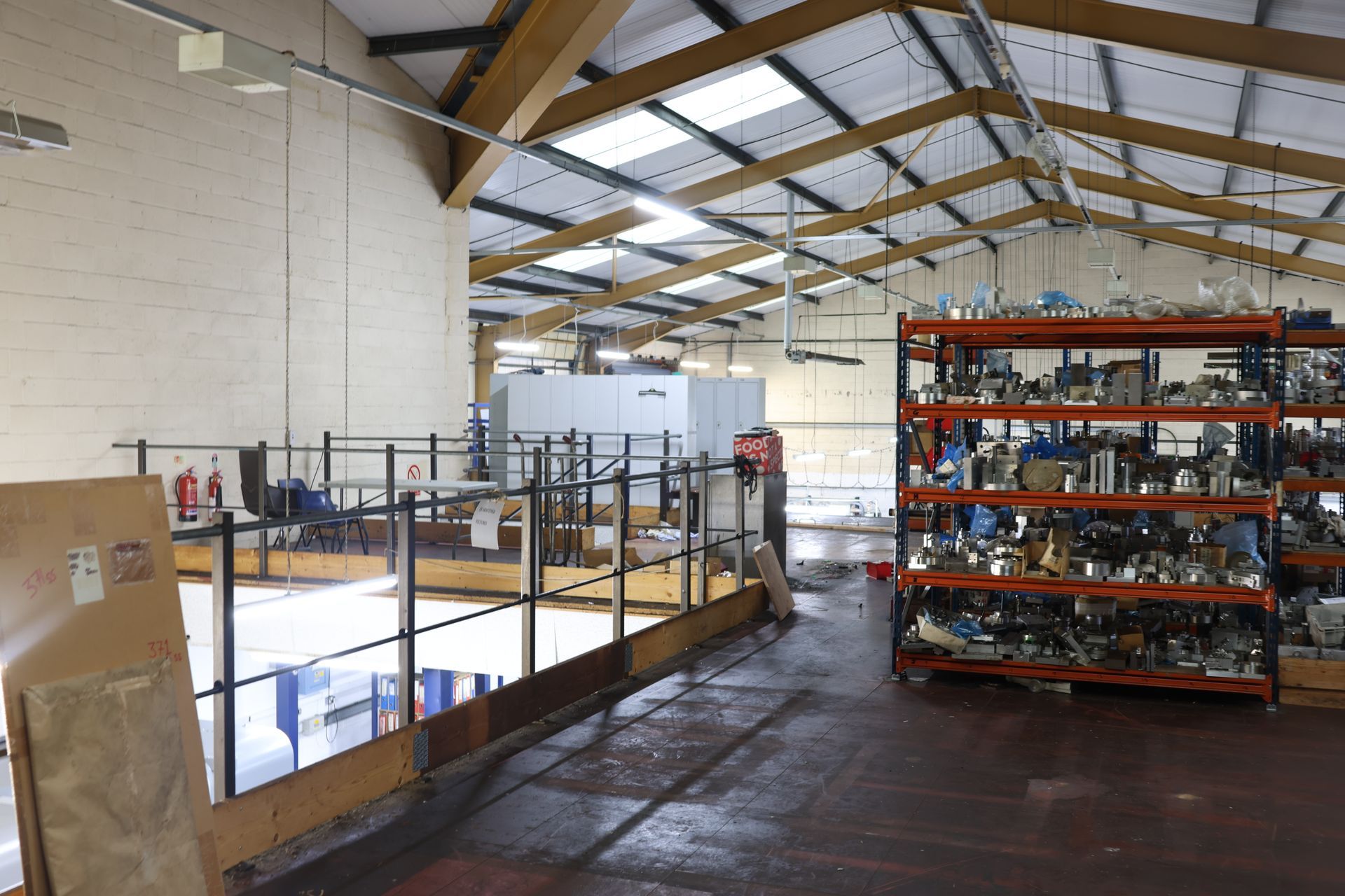 A large warehouse filled with lots of boxes and a fire extinguisher.