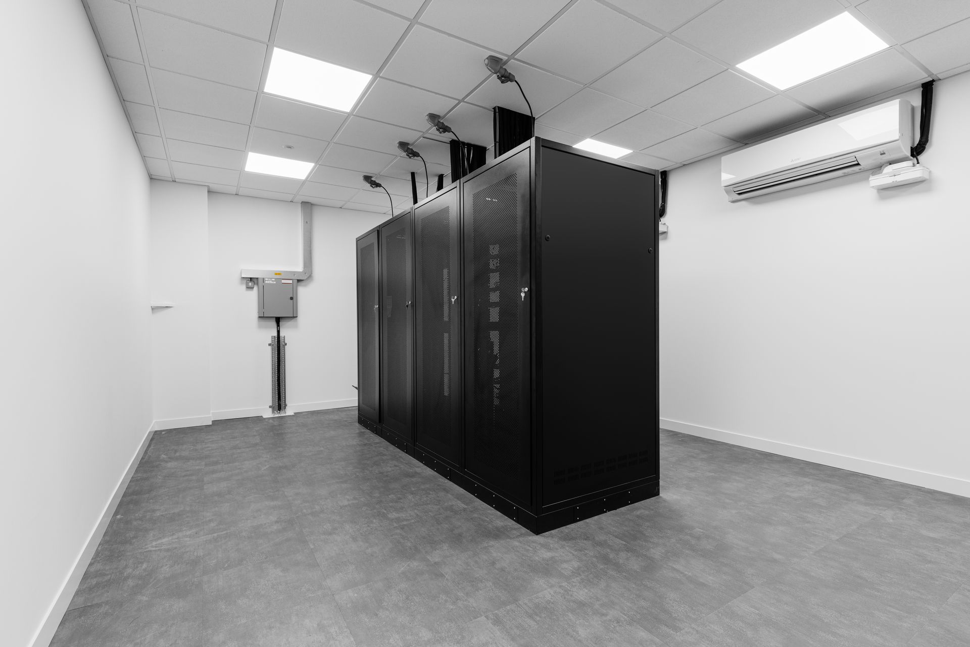 A black and white photo of a server room with a lot of servers.