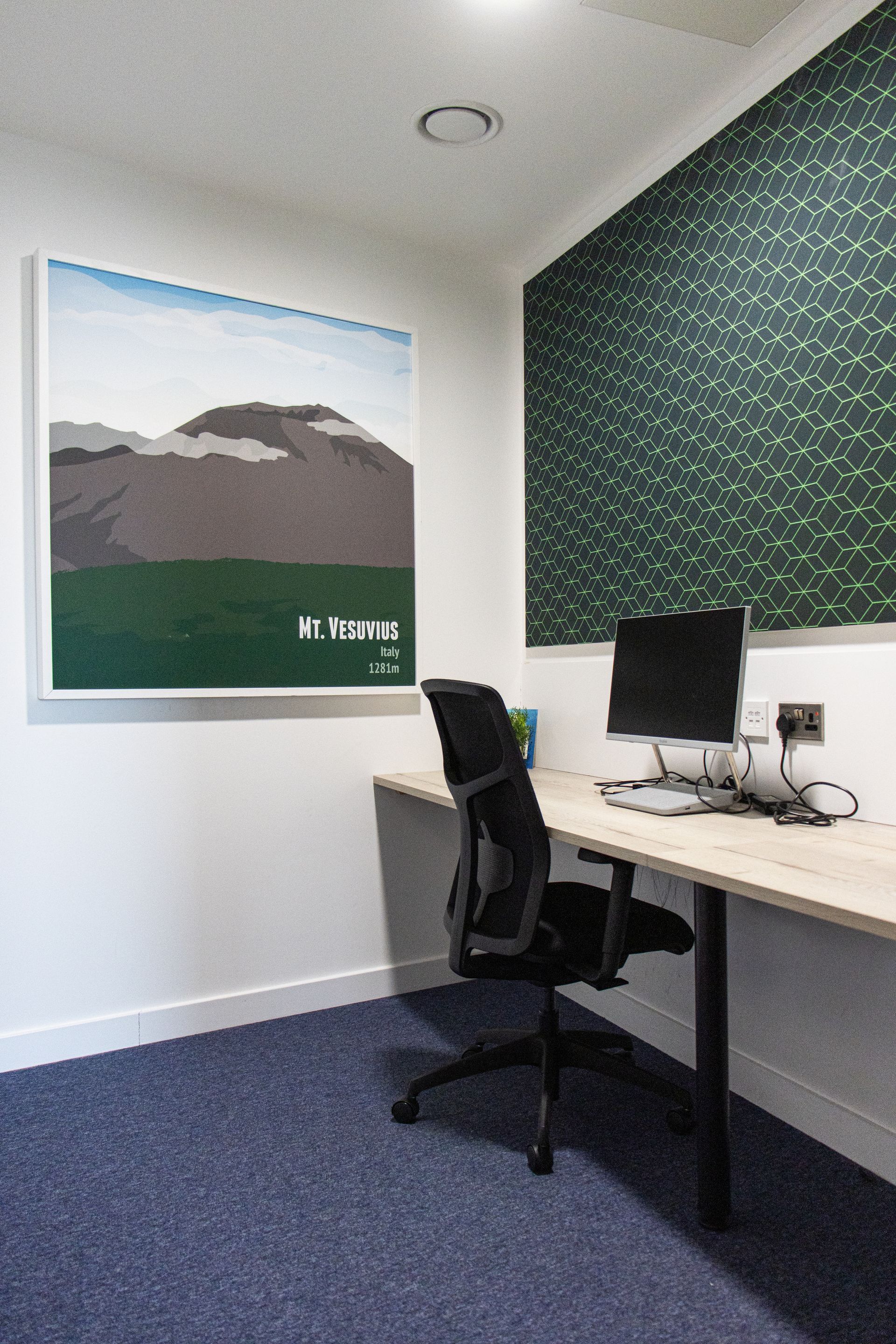 A recliner is sitting in a bedroom next to a nightstand and a lamp.