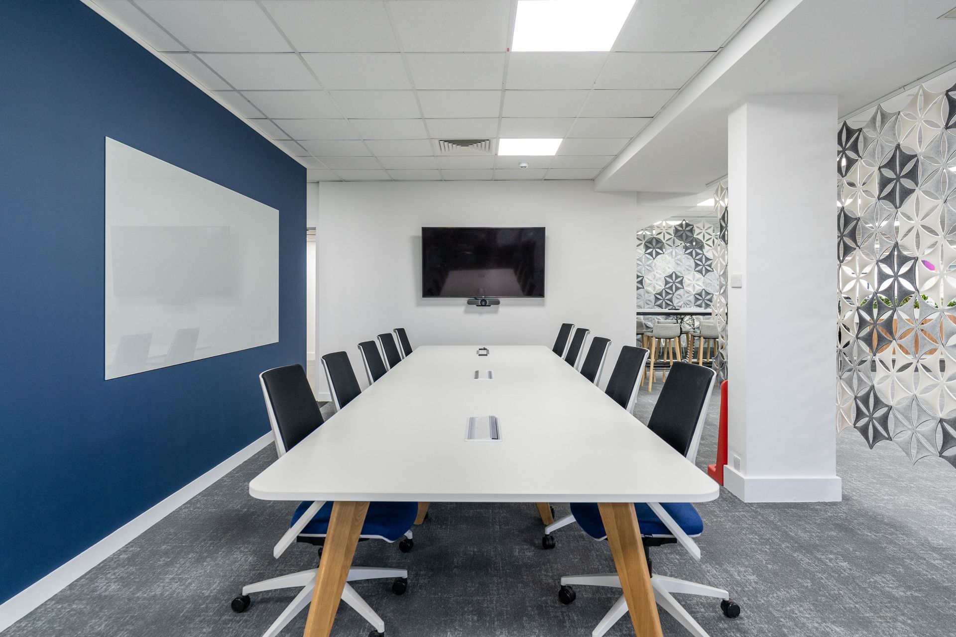 A recliner is sitting in a bedroom next to a nightstand and a lamp.