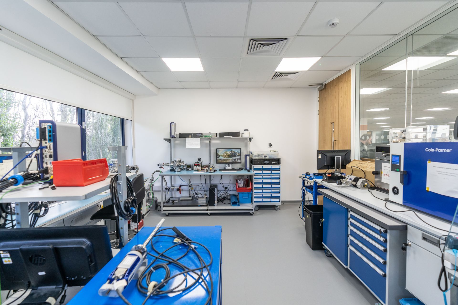 A bright, tidy laboratory with a lot of equipment and windows for natural light.