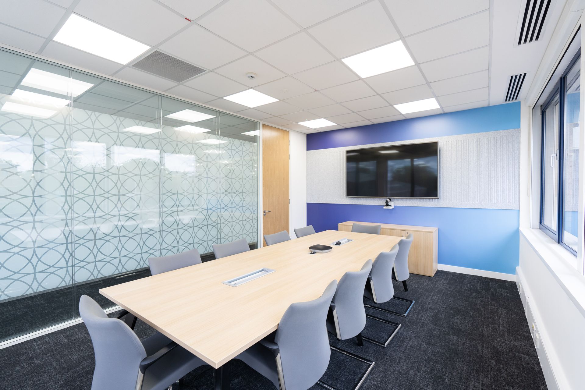A bedroom with a bed , nightstand , and window.
