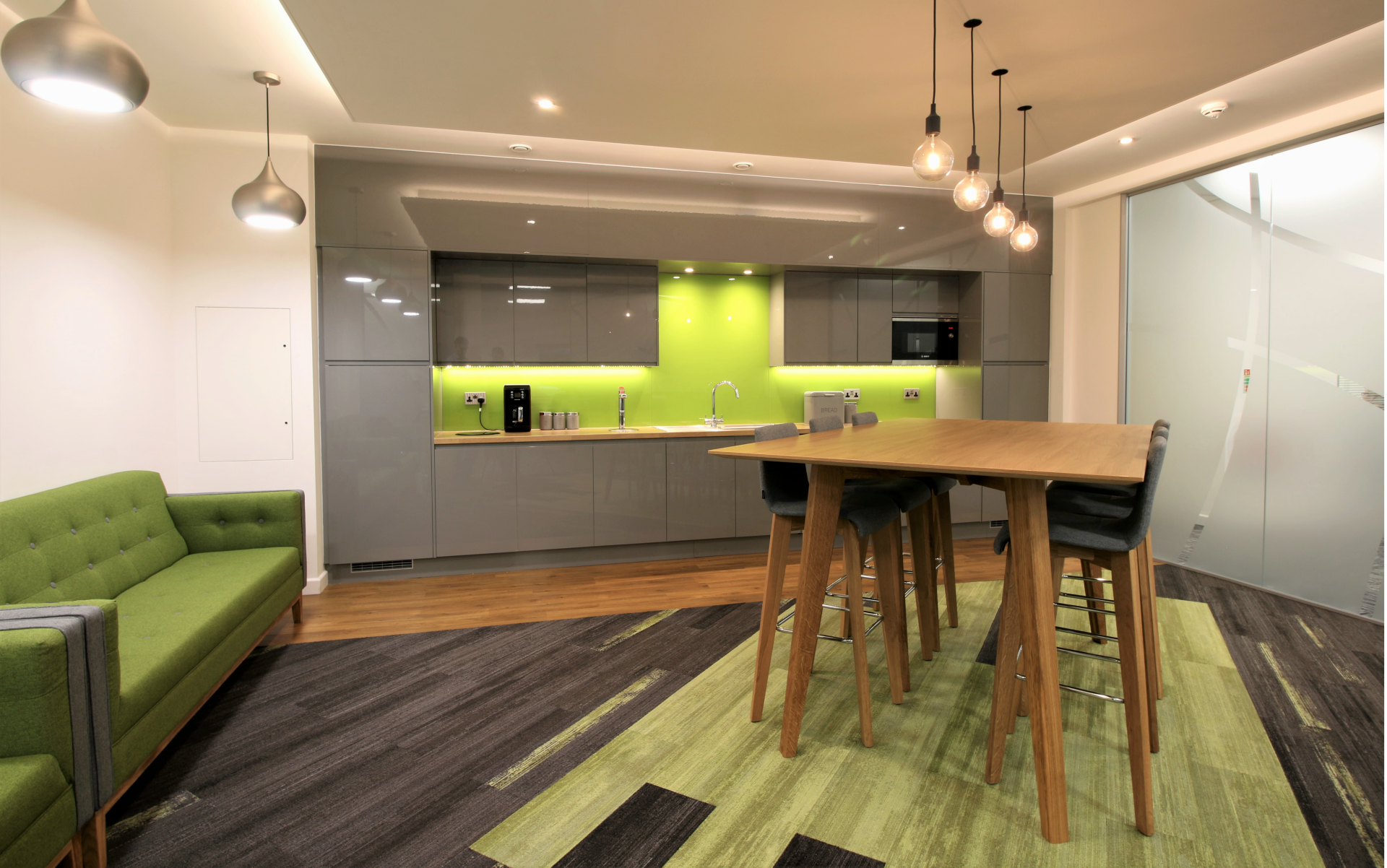 A room with a couch , table and chairs in it.