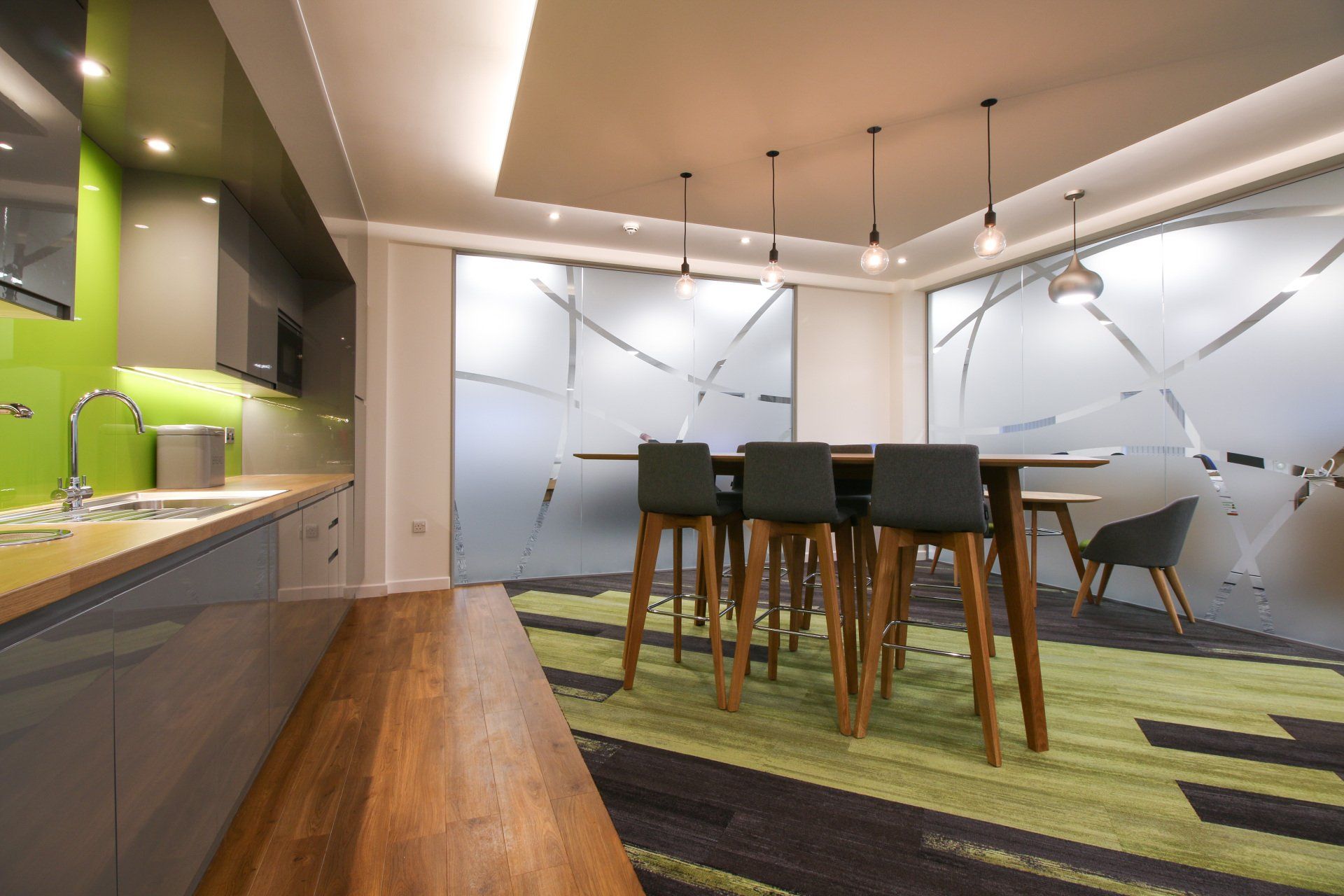 A dining room with a table and chairs in it.