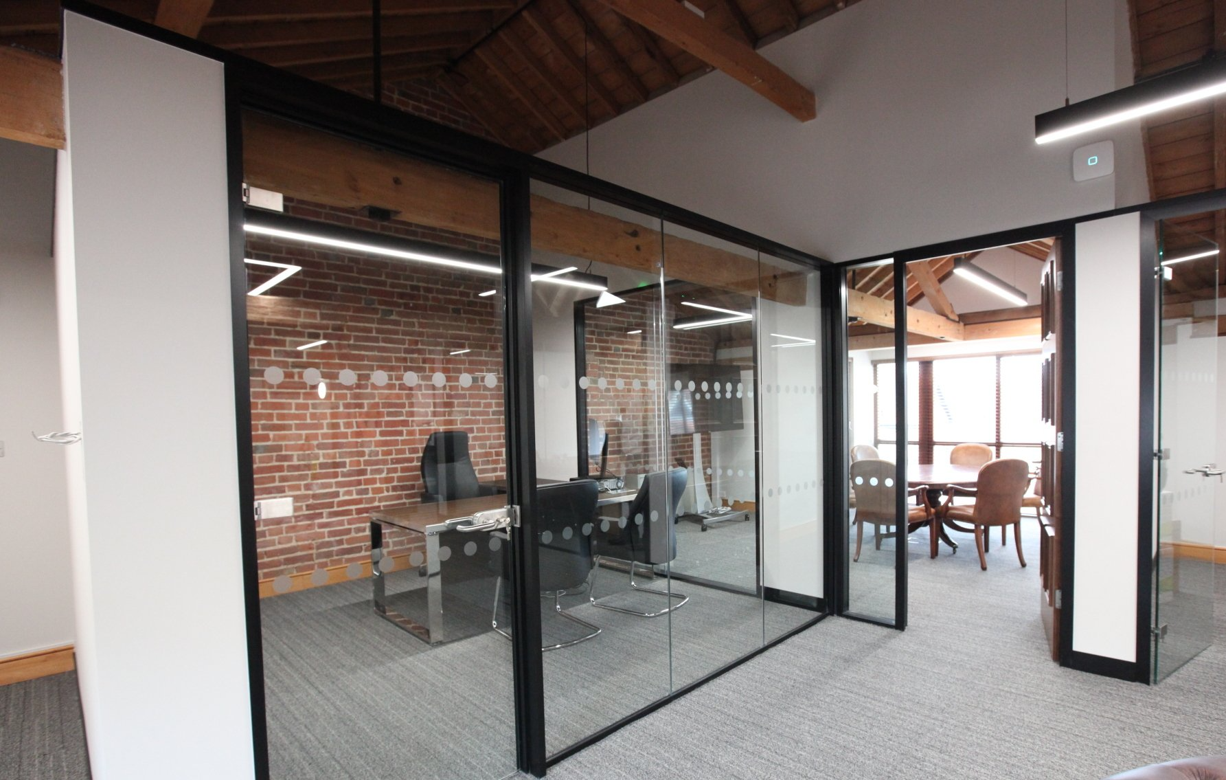 Individual office with glass walls in a barn conversion by Glenside