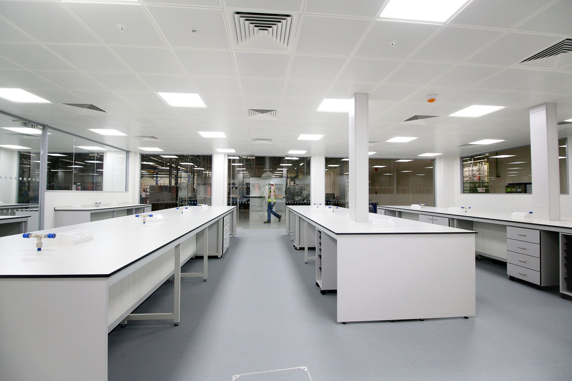 A large research laboratory with white benching.