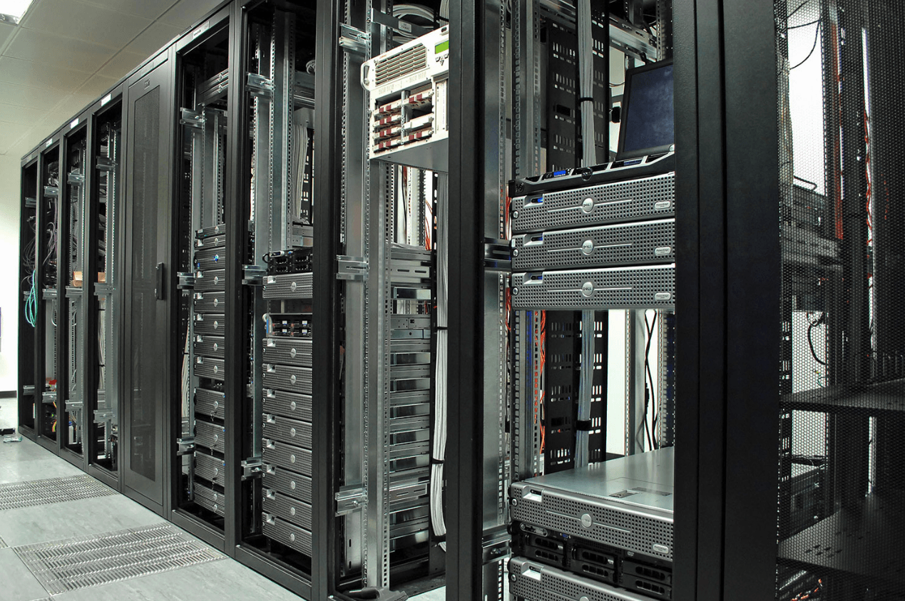 A row of servers are lined up in a server room.