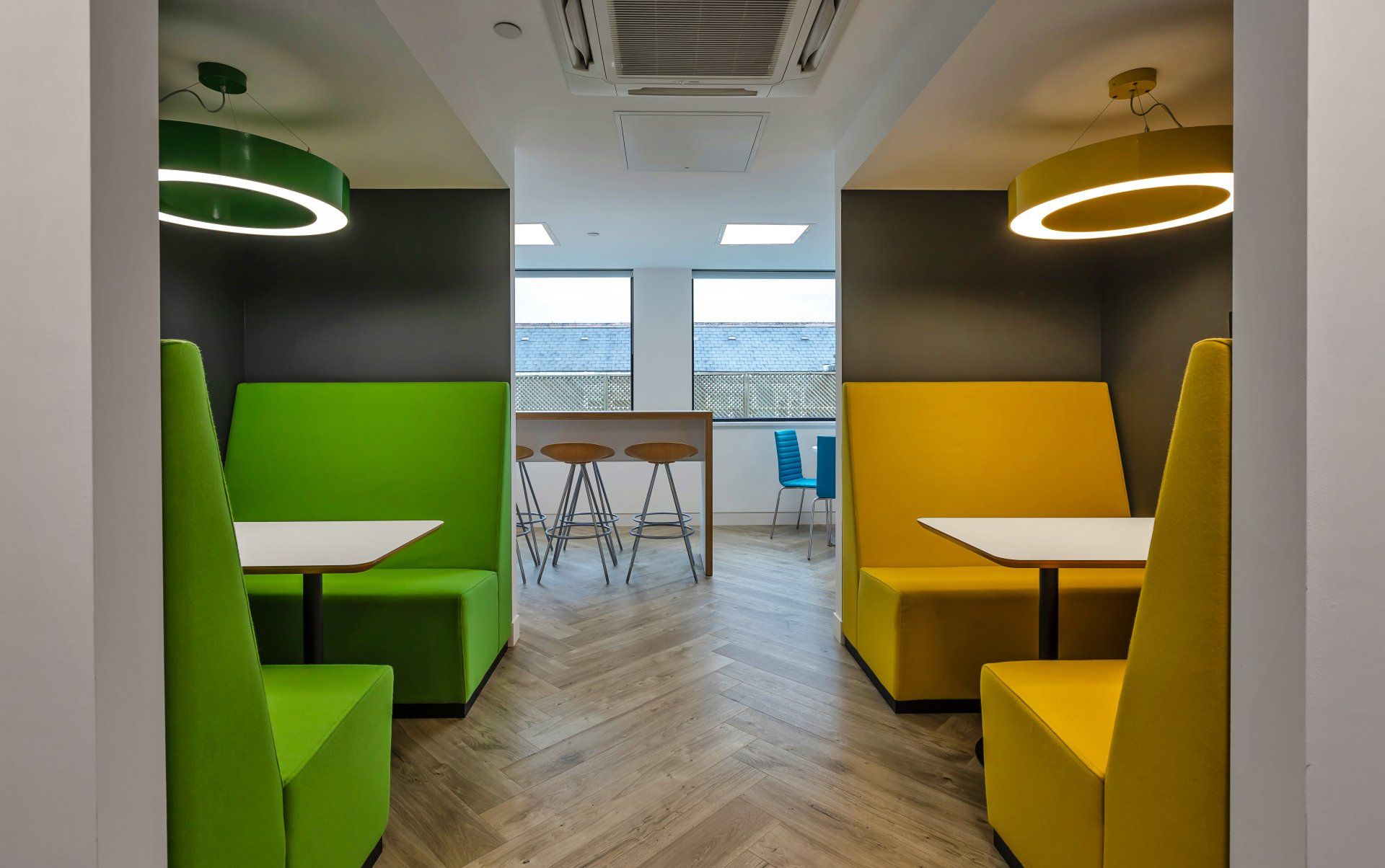 Hybrid working space with green and yellow booth seating by Glenside