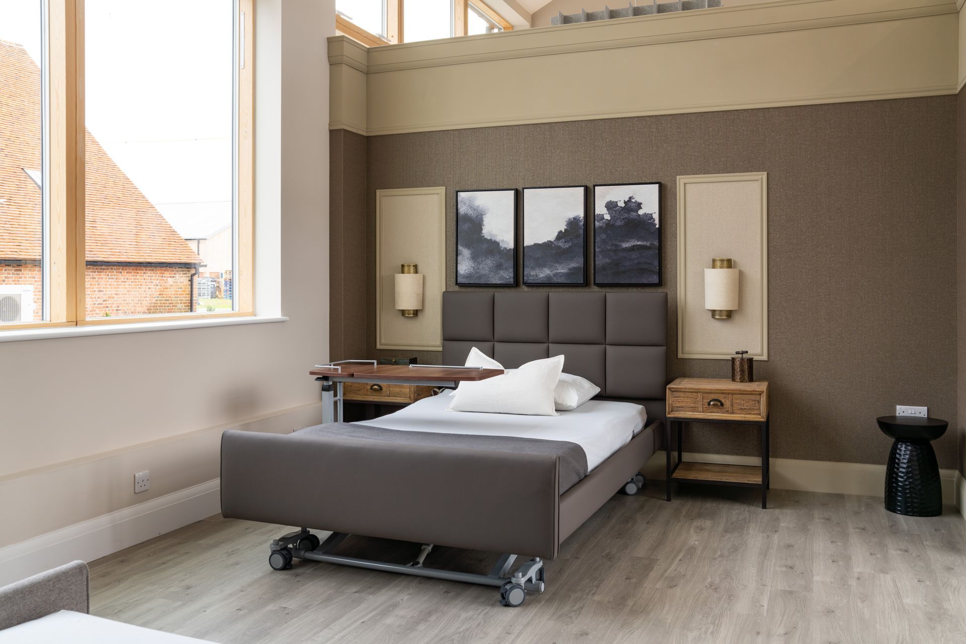 A bedroom with a bed , nightstand , and window.