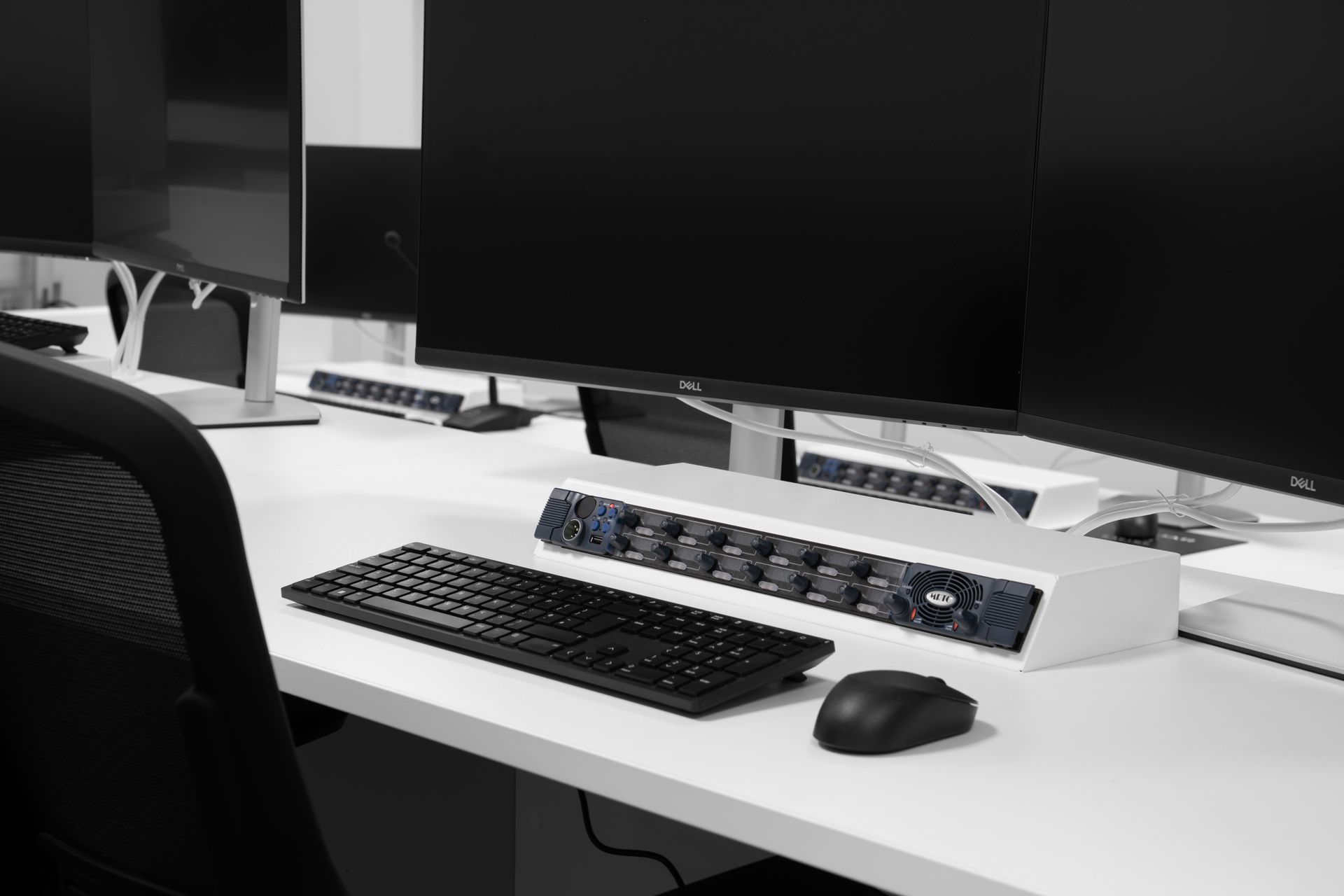 a black and white photo of a desk with a keyboard and mouse on it .