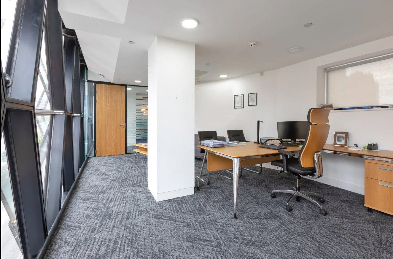 A large office with a desk , chair and computer.