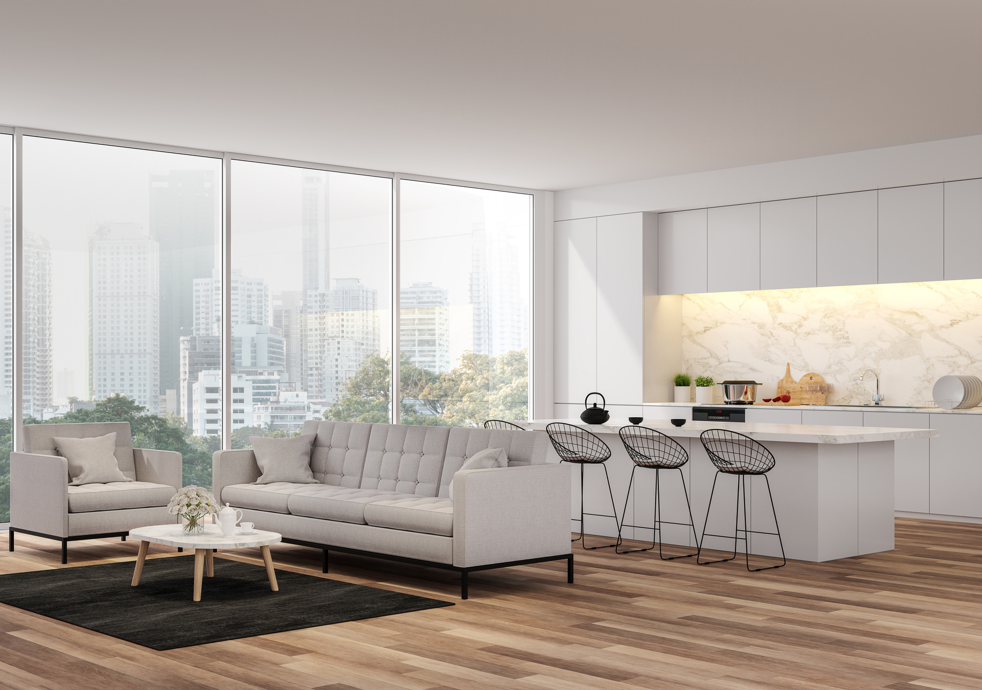 Modern, open-plan living room with light gray furniture, kitchen island, and floor-to-ceiling windows overlooking a city.