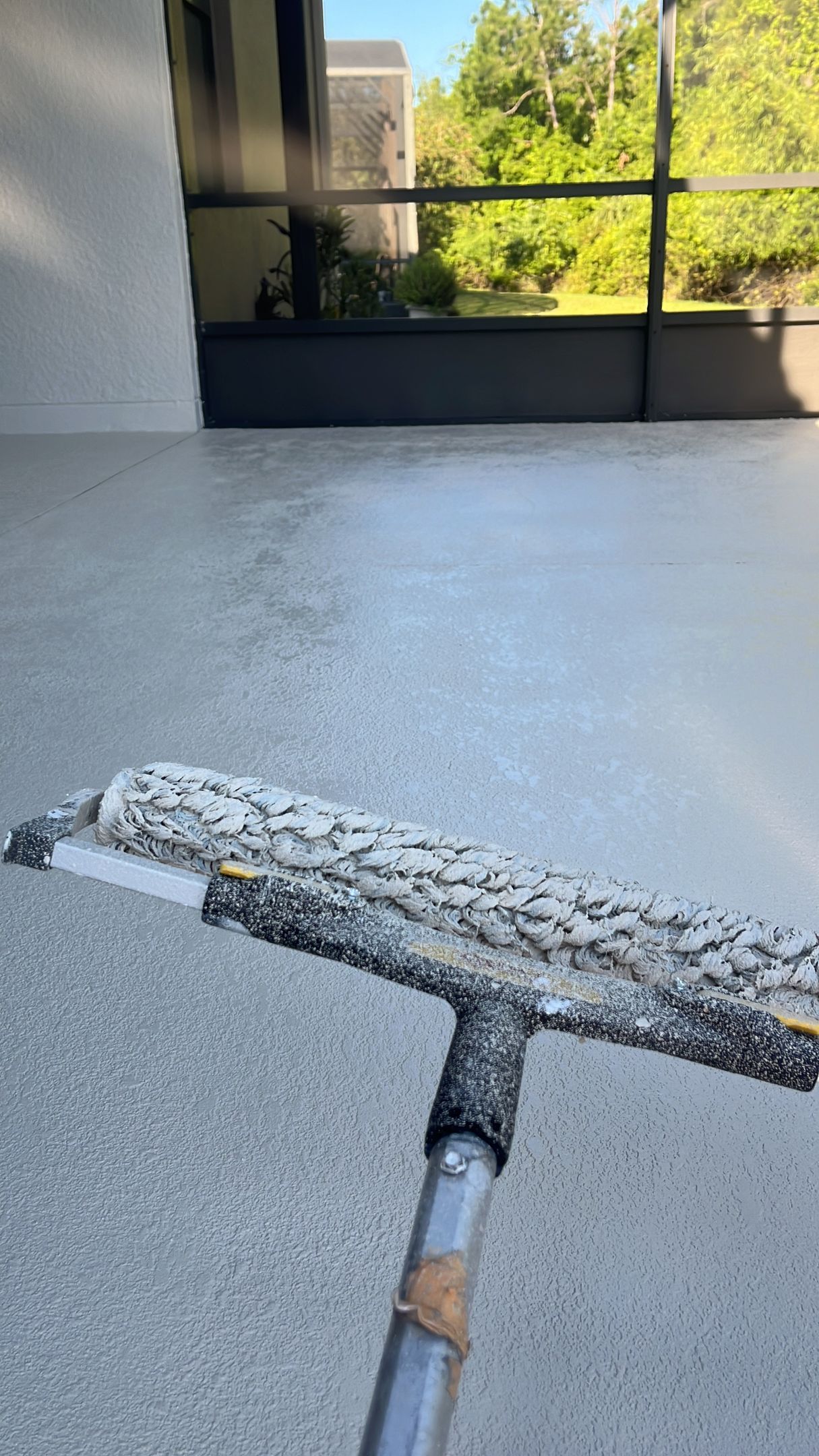 Paver sealing in progress on a patio using professional-grade application for long-lasting surface protection.