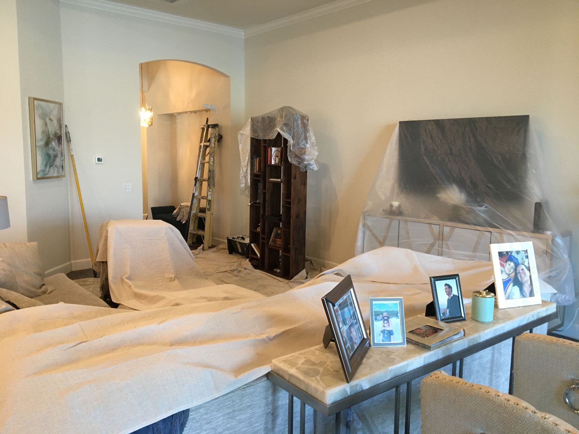 Home interior covered in protective sheets, prepared for residential interior painting services.