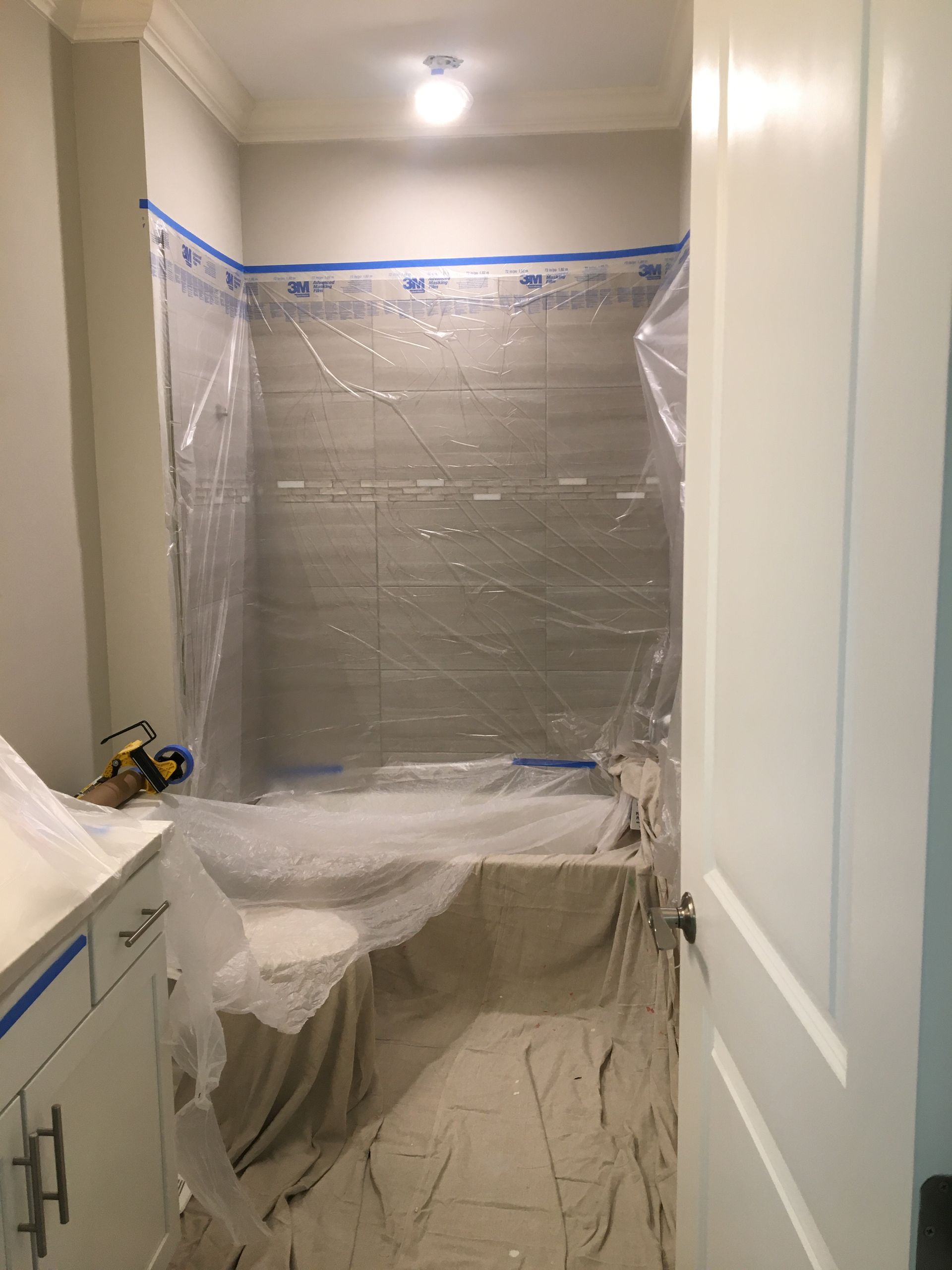 Bathroom covered with protective plastic sheeting for deep cleaning services or move in and move out cleaning.