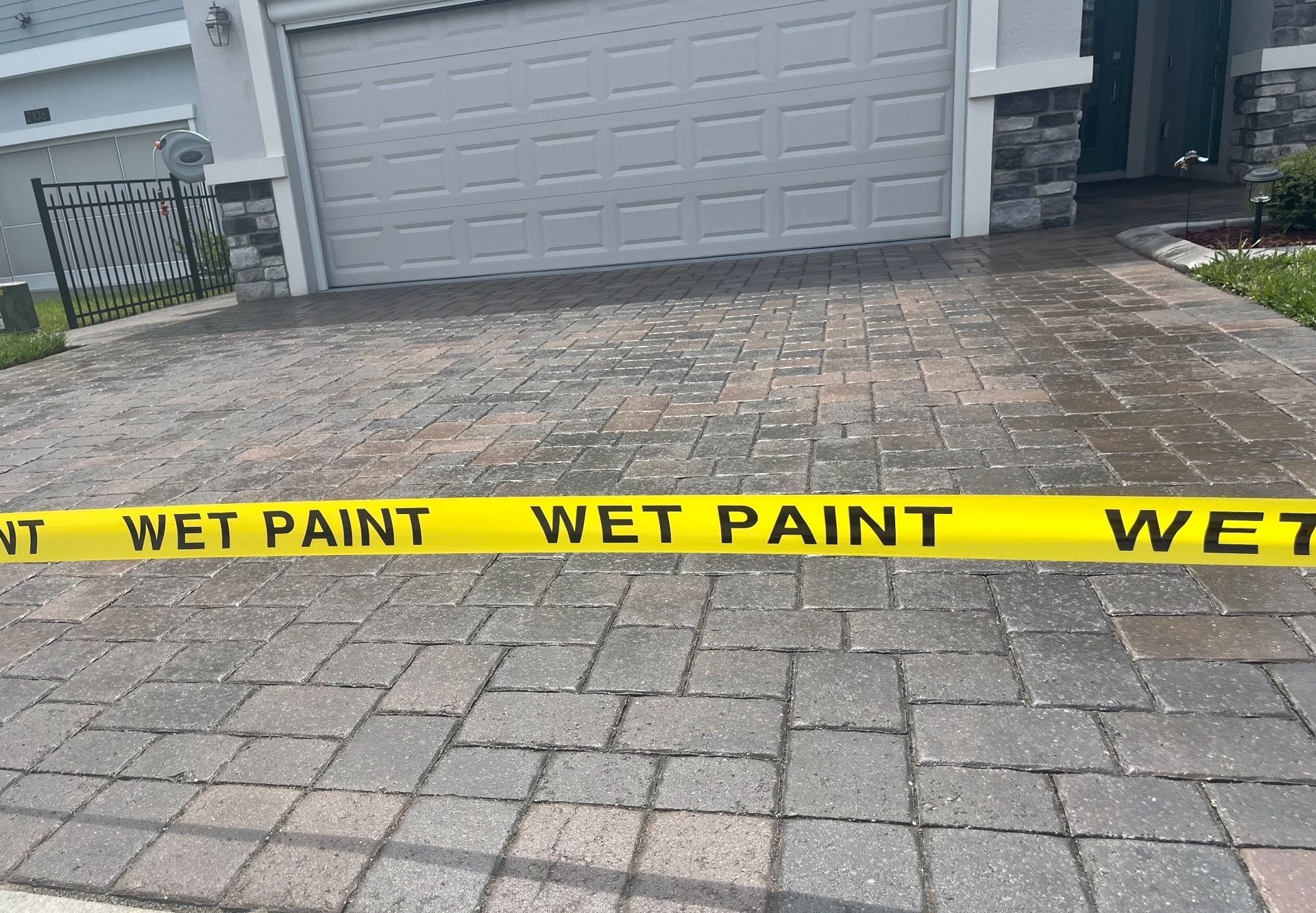  Sealed brick driveway with a smooth finish, part of professional paver sealing services.