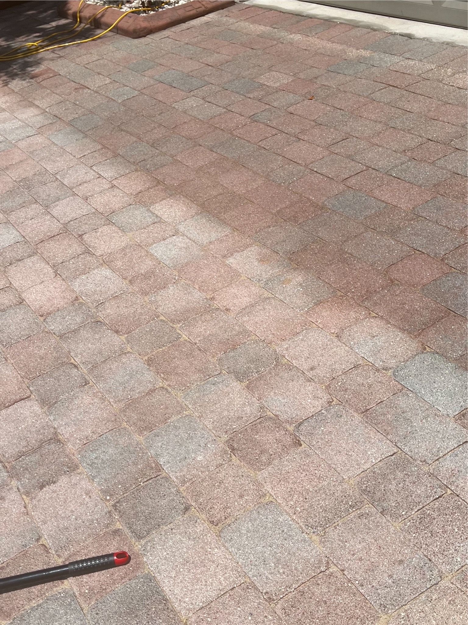  Close-up of wet pavers, illustrating paver sealing and cleaning benefits for long-term preservation.