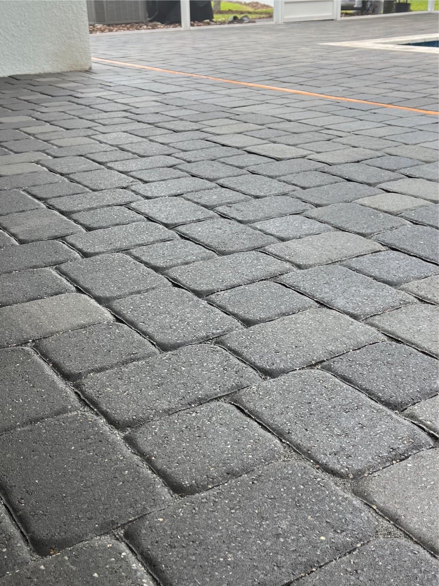 A close up of a brick driveway in a parking lot.