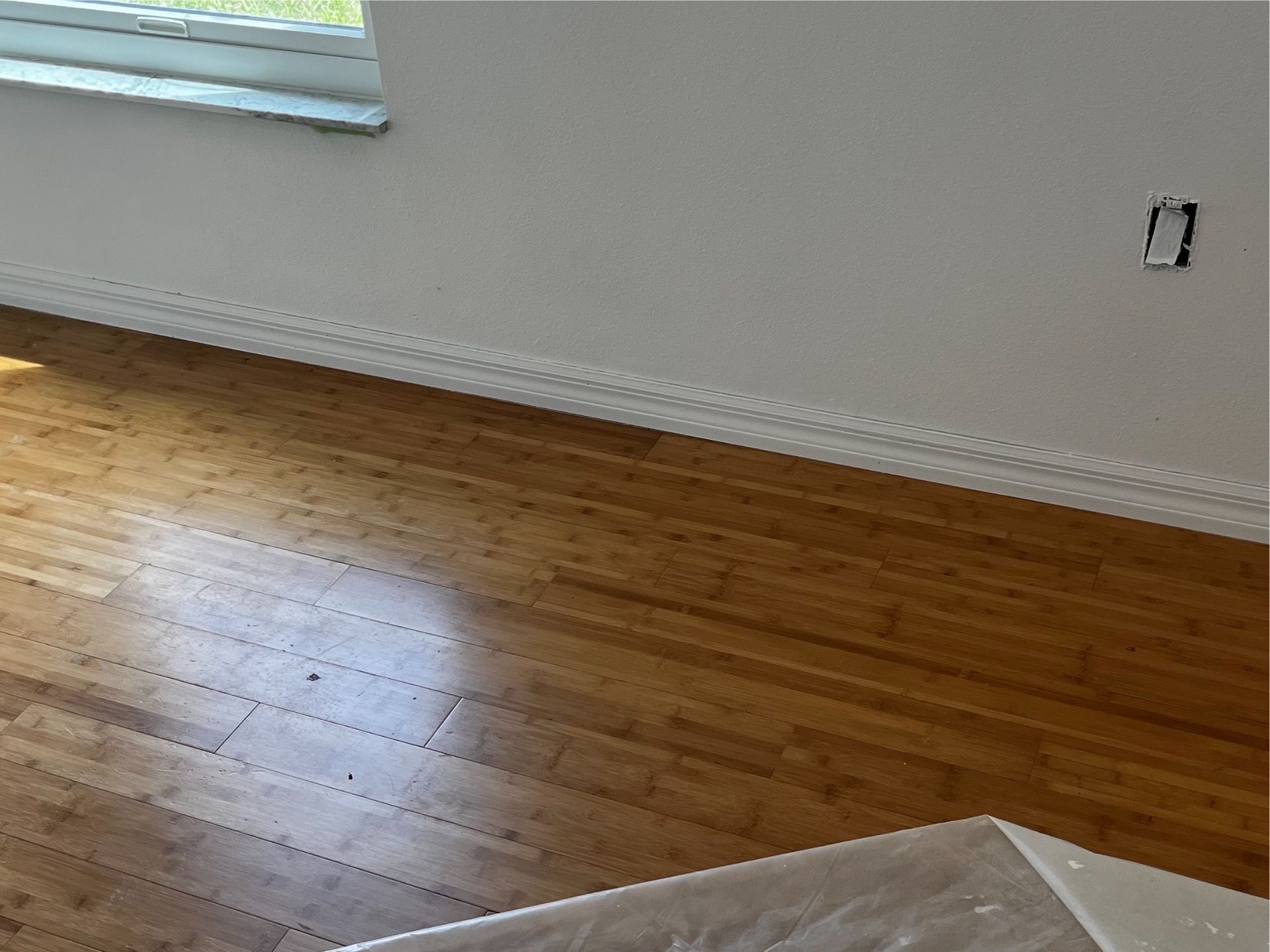 A room with a wooden floor and a window