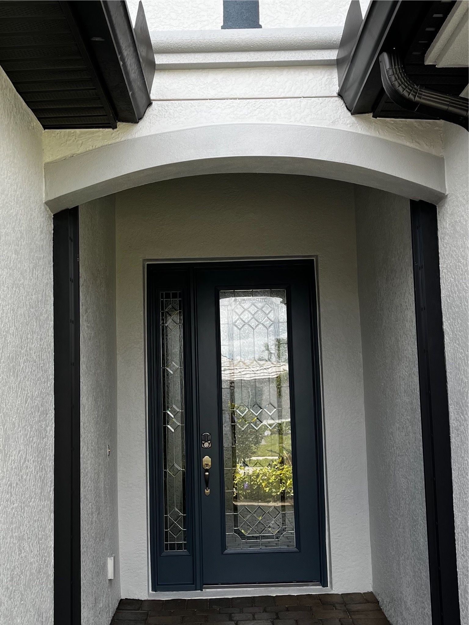 The front door of a house with a black door