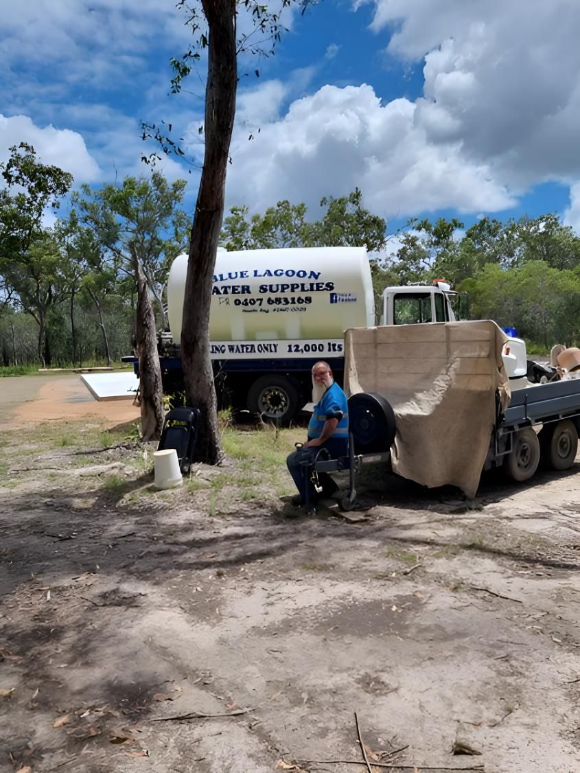 A Man Is Sitting On A Bench In Front Of A Truck — Blue Lagoon Water Supplies In Fraser Coast, QLD